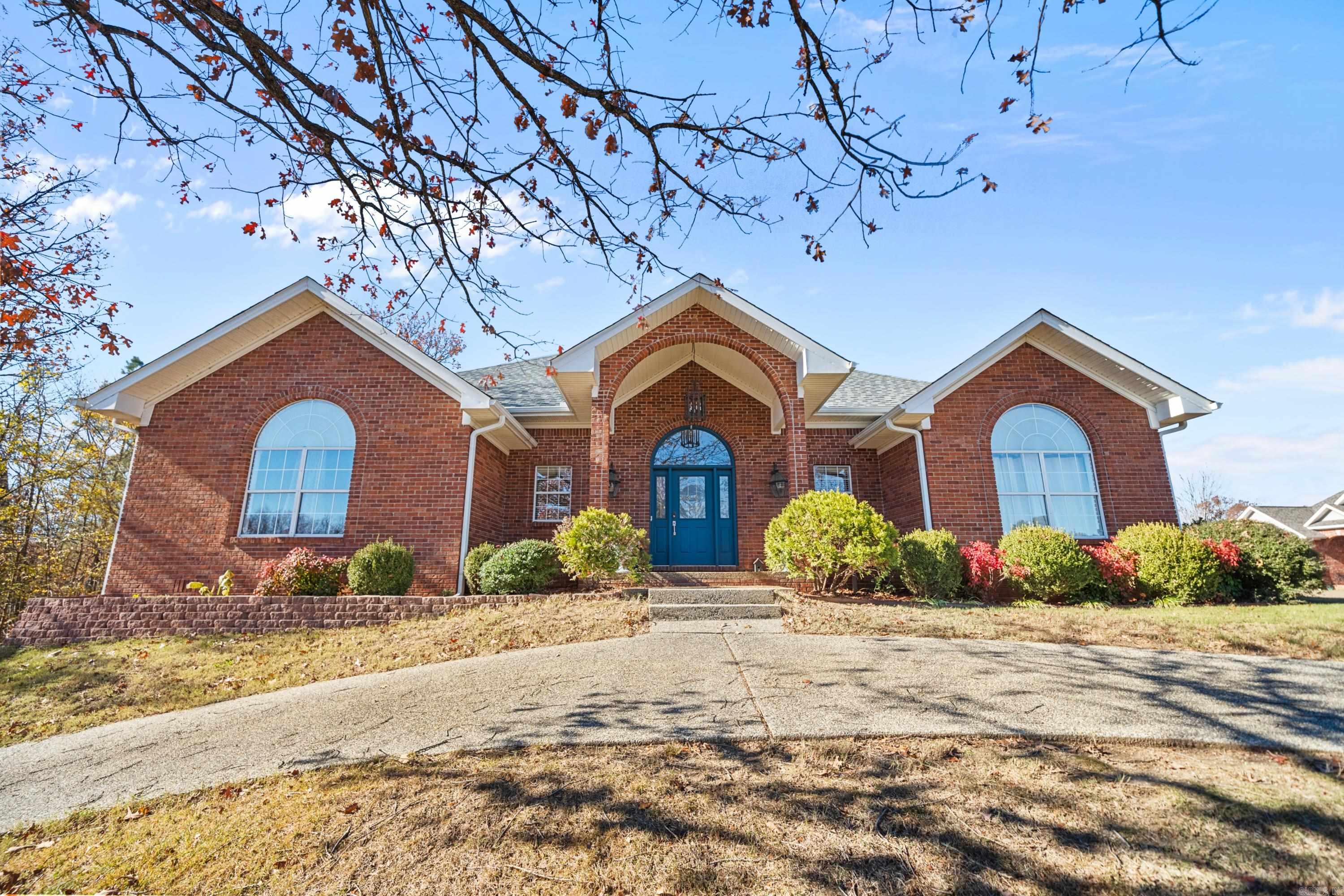 This immaculate one-level home is nestled on a spacious corner lot within Wildwood Forest Subdivision. You'll love having your own private oasis, featuring an inviting in-ground pool with a charming pool-house & cabana/bar; and the fully-fenced backyard ensures complete privacy for relaxation and fun. Inside, the floor plan features 3-bedrooms, 2-bathrooms, and an Arkansas room with tranquil space, offering indoor comfort while soaking up the pool views. The heart of the home, the kitchen, includes a stainless gas cooktop and a cozy hearth room with custom built-in shelving, perfect for entertaining guests or family dinners. Retreat to the spacious master suite, complete with an updated tiled shower, double vanity, and a soaker tub - and the master offers private Arkansas room access as well. Hardwood floors grace the main living areas, and the living room features a second gas fireplace, ideal for cold evenings. Experience the peace of Hidden Forest Subdivision in Lake Hamilton School District, a quiet and pristine neighborhood. What a wonderful place to call "home".