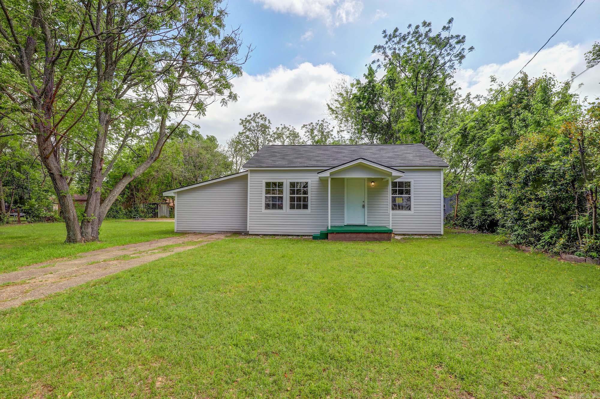 a charmingly updated cottage-style home on two lots. Featuring two living areas, new appliances, central heat/air, and new lighting, this residence offers modern comfort with classic appeal. Step outside to a fenced yard with a covered patio, perfect for entertaining or relaxing. Plus, a spacious slab presents opportunities for a workshop or outdoor dining area. Don't miss the chance to call this special property home.