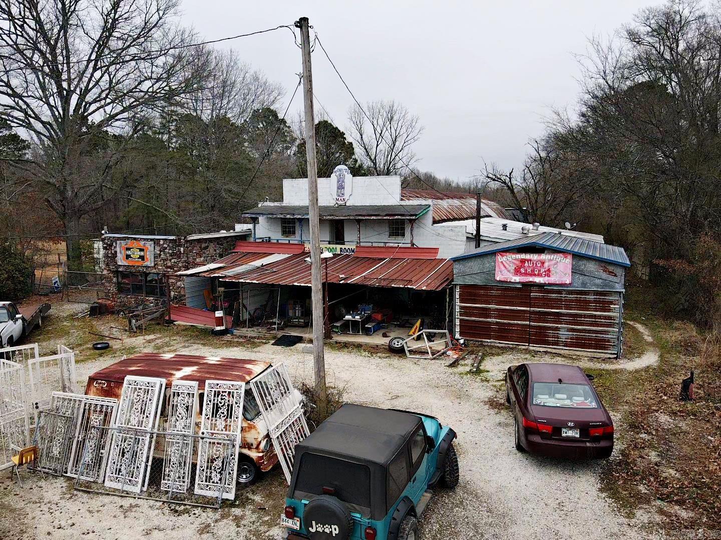 Endless possibilities with this SPACIOUS COMMERCIAL property. Highly visible location with heavy traffic count. There is an office, a loading dock and tons of storage space. Also included is a 2 BR/1 BA mobile home with a porch. Property includes the building, acreage, and mobile home only. Building contents and items on the exterior and yard DO NOT CONVEY! BEING SOLD AS IS!