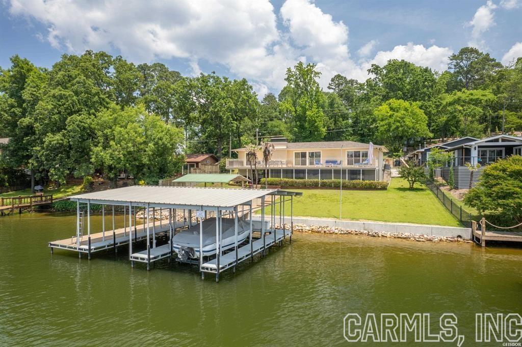 Fully remodeled lake home on prestigious Long Island Drive, consisting of three bedrooms, two full baths & two half baths. Very sought-after location in Lakeside School District! The features are numerous and include a chef's kitchen equipped with high end Viking appliances, original hardwood floors, master bedroom & bath on the main level, fully integrated smart home with Control 4 automation, whole home generator, two stall covered boat dock, expansive deck overlooking the lake, and the list goes on. The lower level is ideal for extra guests and is equipped with a separate kitchenette/bar area. The back yard is beautifully landscaped and has wonderful lake views. A brand new concrete seawall was just installed. Entergy has also approved a permit to build a boardwalk along the lakefront. This permit will convey to the new buyer.