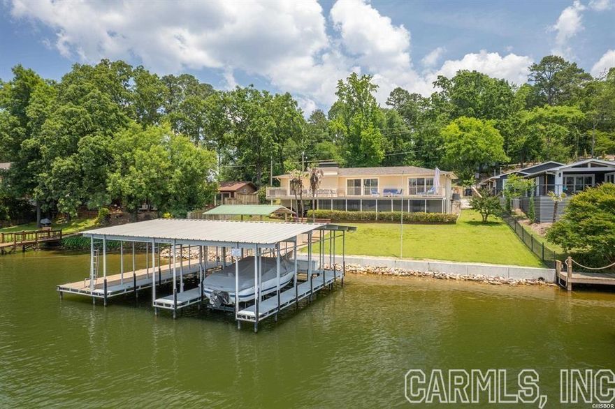 Fully remodeled lake home on prestigious Long Island Drive, consisting of three bedrooms, two full baths & two half baths. Very sought-after location in Lakeside School District!  The features are numerous and include a chef's kitchen equipped with high end Viking appliances, original hardwood floors, master bedroom & bath on the main level, fully integrated smart home with Control 4 automation, whole home generator, two stall covered boat dock, expansive deck overlooking the lake, and the list goes on.  The lower level is ideal for extra guests and is equipped with a separate kitchenette/bar area. The back yard is beautifully landscaped and has wonderful lake views. A brand new concrete seawall was just installed. Entergy has also approved a permit to build a boardwalk along the lakefront. This permit will convey to the new buyer.