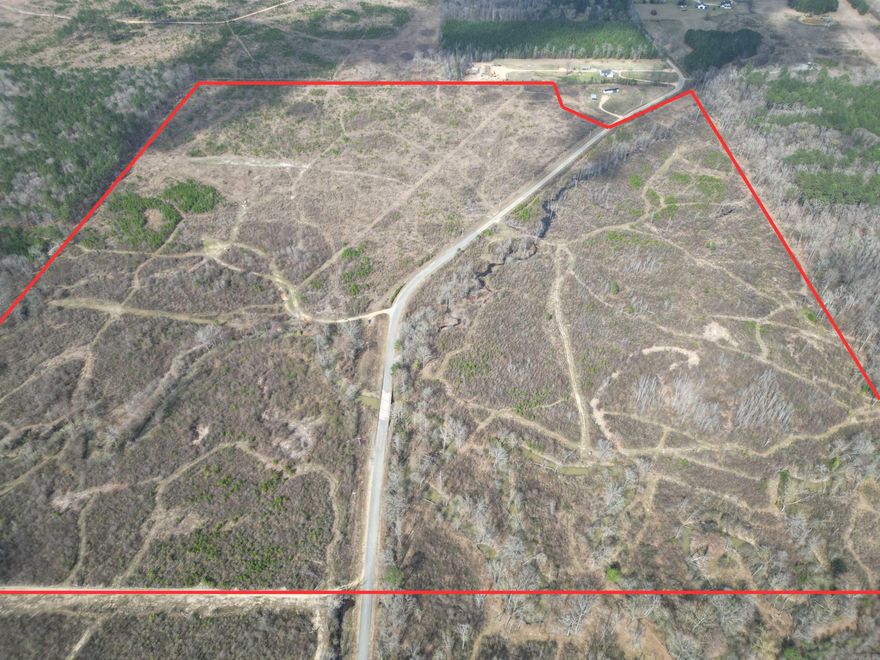 Escape to your own private outdoor paradise on 152.72 +/- acres loaded with wildlife and ready for adventure. This property is set up for serious hunters and outdoor enthusiasts, featuring multiple established trail systems, deer stands, feeders, and food plots already in place.  A creek runs through the property, along with several wildlife ponds, creating the perfect habitat for deer, turkey, hogs, and ducks. The land also includes a long-range shooting area, making it ideal for practicing or dialing in your next hunt.  The property offers highway frontage with utilities available at the highway, and there is a potential camper location on the northeast corner, providing a great spot for a hunting camp or weekend getaway.  If you’re looking for a turn-key hunting tract with excellent wildlife habitat, water features, and easy access, this property checks all the boxes.