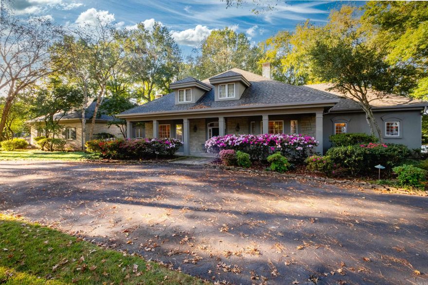 Stunning & special property on the Arkansas River!  This home was beautifully built with a limestone front & showcases great views of the water from most every room.  The property is expansively spread over 3 lots - over 1/2 an acre of lush landscaping, flagstone walkways & nature all around.  Everything is on one level & the rooms are generously sized & well balanced.  Inside features pretty hardwoods, high ceilings, tasteful archways making it the best home for entertaining friends & family.  Plenty of room to park on the circular & side driveways. This home also offers privacy & the location is tucked away, very quiet. Check out the extremely large kitchen with limestone hearth area w/ granite & Corian counters & lots of natural light.  The primary suite is apart with TWO bathrooms, one has its own sitting area overlooking the river.  Off the kitchen are 2 bonus spaces that would make great office/craft/hobby areas & the laundry room is large.  The separate hot tub house is approx 268 Sq Ft, hot tub not warranted.  Large garage space plus workshop area. The roof, leaf guard gutters & exterior paint were done in the past year. 3 zones HVAC system. Agents see remarks!