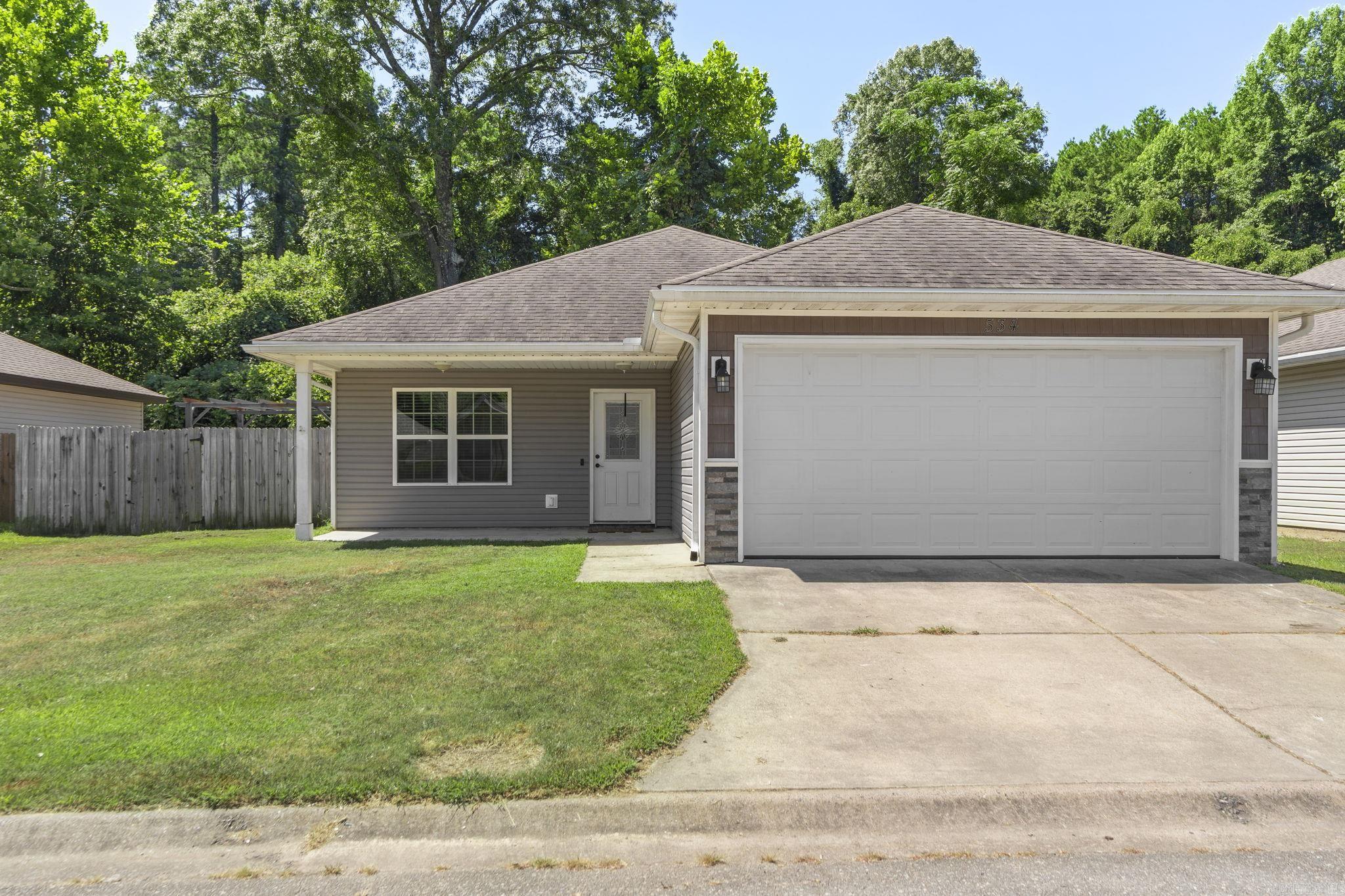 Welcome Home to Bauxite Charm! This adorable 3-bedroom, 2-bath home has all the cozy vibes with modern touches! The open floor plan features a stunning granite-topped islandāperfect for gatherings or casual meals. You'll love the easy-to-maintain fenced yard that backs up to peaceful, wooded landāno backyard neighbors here! Sip your morning coffee on the spacious covered front porch and soak in the small-town feel. Complete with a separate laundry room and a 2-car garage, this home is move-in ready and waiting for you!