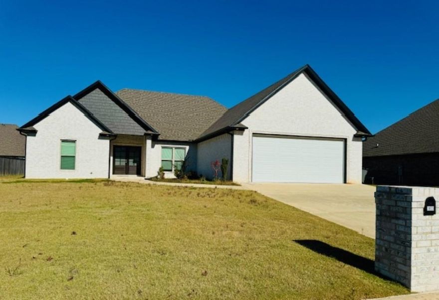 Welcome to your dream home in Paragould's sought-after Shadow Ridge Subdivision! This stunning 4-bedroom, 3-bathroom single-family home offers 2,560 sq. ft. of beautifully designed living space. Built in 2021 and sitting on a spacious 0.29-acre lot, this home features a split floor plan, perfect for both privacy and entertaining. Inside, you'll love the vaulted ceilings, gas log fireplace, and large windows that flood the open living space with natural light. The kitchen boasts double ovens and ample storage, with the refrigerator negotiable. The primary suite impresses with a double tray ceiling, an amazing walk-in closet, and a luxurious ensuite bath. Additional highlights include: Primary Suite has its own dedicated water heater, Massive Walk in Pantry, Jack-and-Jill bath connecting bedrooms 2 and 3, Private bath and patio access from bedroom 4, Double closets in bedrooms 2,3 & 4, Pocket doors where convenient, Covered rear patio with additional grilling patio for outdoor enjoyment, Attached large 2-car garage, Tile-floored laundry room & bathrooms, & Hardwood throughout living areas. Located in the Greene County Tech School District, this home is move-in ready