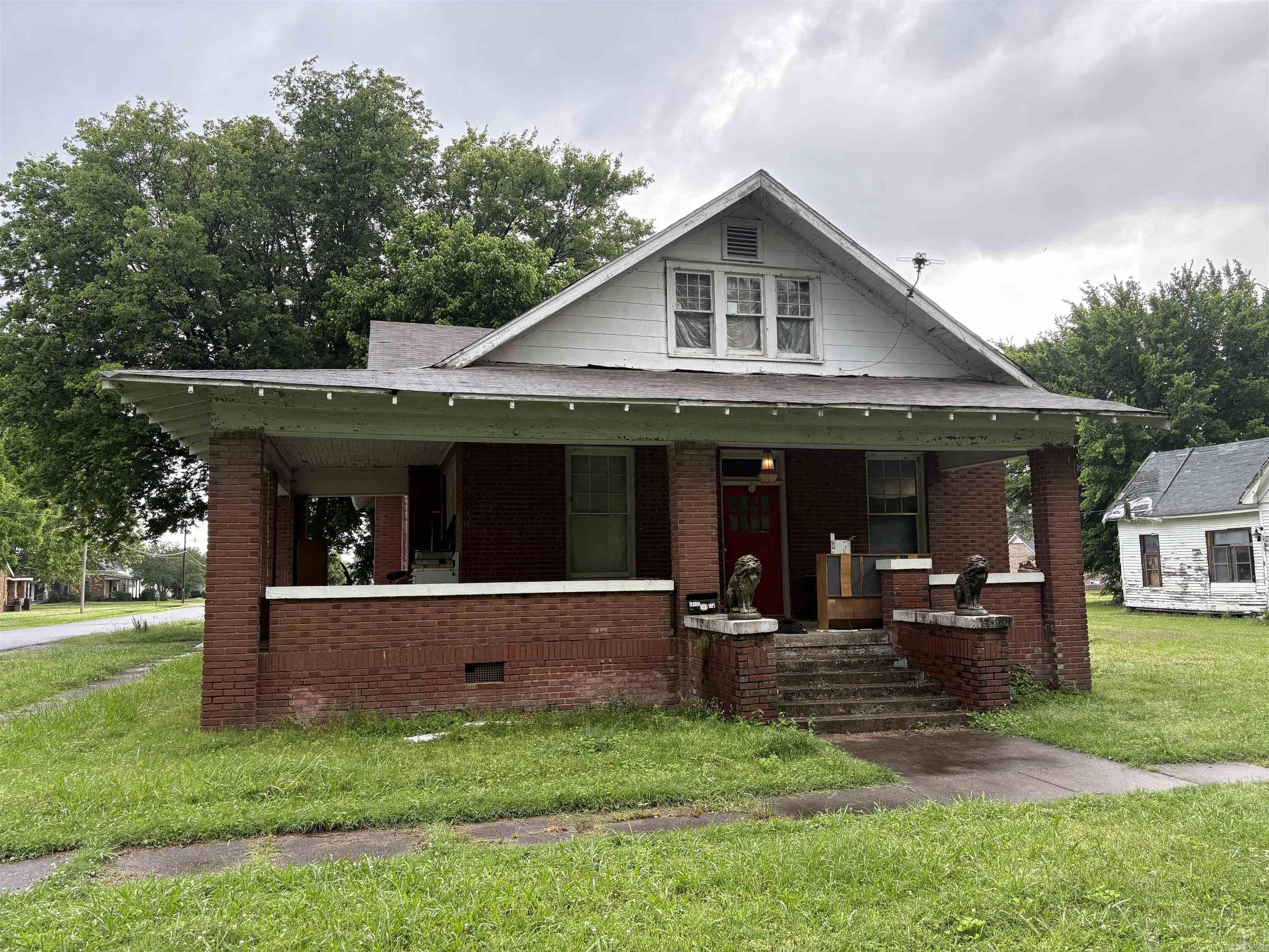 Nestled off NE 4th St and St. John, this spacious five-bedroom, two-bath home offers classic charm with a brick exterior and a welcoming covered front porch. Inside, you'll find hardwood floors throughout most of the home, a generous kitchen with ample cabinet space, and plenty of room for a growing family or hosting guests. Out back, a large, solidly built garage/workshop provides versatile space for storage, hobbies, or outdoor gear. Situated in the heart of a thriving farming community and renowned duck hunting region, this property is ideal for those who love the outdoors. Being sold as is, this home is a perfect canvas for updates and personal touches. With the right improvements, it could serve as a comfortable full-time residence or a fantastic home base for hunters and their families.