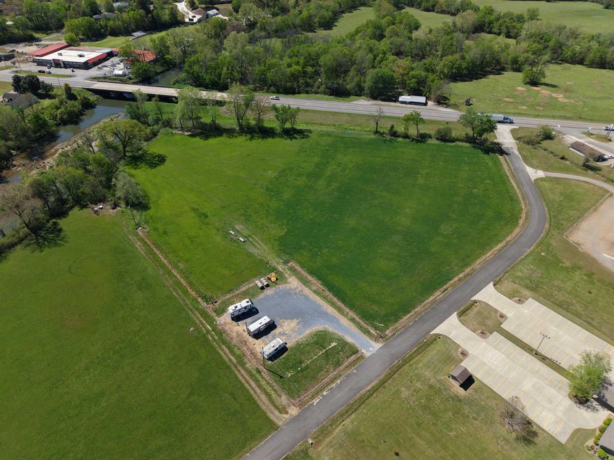 Discover the potential of this approx. 7.7-acre property in Mount Ida, AR, offering a rare combination of river frontage, highway access, and income-producing features. With approximately 300 feet of frontage along the Southfork of the Ouachita River, this property provides direct access to one of the area’s most sought-after natural resources. A new survey has already been completed, and the land is equipped with city water and city sewer—an uncommon and valuable advantage for rural acreage.  Currently set up with four full-service RV sites, each with 50-amp hookups, this property is already generating income and ready for continued use or future expansion. With approximately 700 feet of Highway 270 frontage, visibility and accessibility are excellent. The property is fenced for livestock and offers flexibility with no restrictions, making it ideal for development, recreation, or investment. Conveniently located just 11 miles from Twin Creeks Recreation Area, 15 miles from Mountain Harbor, and 37 miles from Hot Springs, this is a versatile opportunity near Lake Ouachita.
