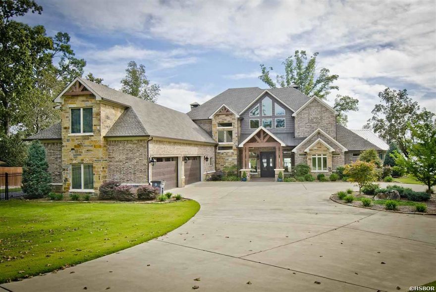 Breathtaking waterfront property on Lake Hamilton with approximately 352' of prime shoreline. Upscale custom features galore from the warm colored wood beams, to the stone and brick accents. Upscale chef's kitchen w/all the bells and whistles. Spacious family room w/a floor to ceiling fireplace & windows. It features a one of a kind upscale indoor/outdoor room w/ lake views, wood burning FP, Grill.Pantry doubles as a security hub & safe room (built to FEMA specifications). Four car garage. Boat Dock