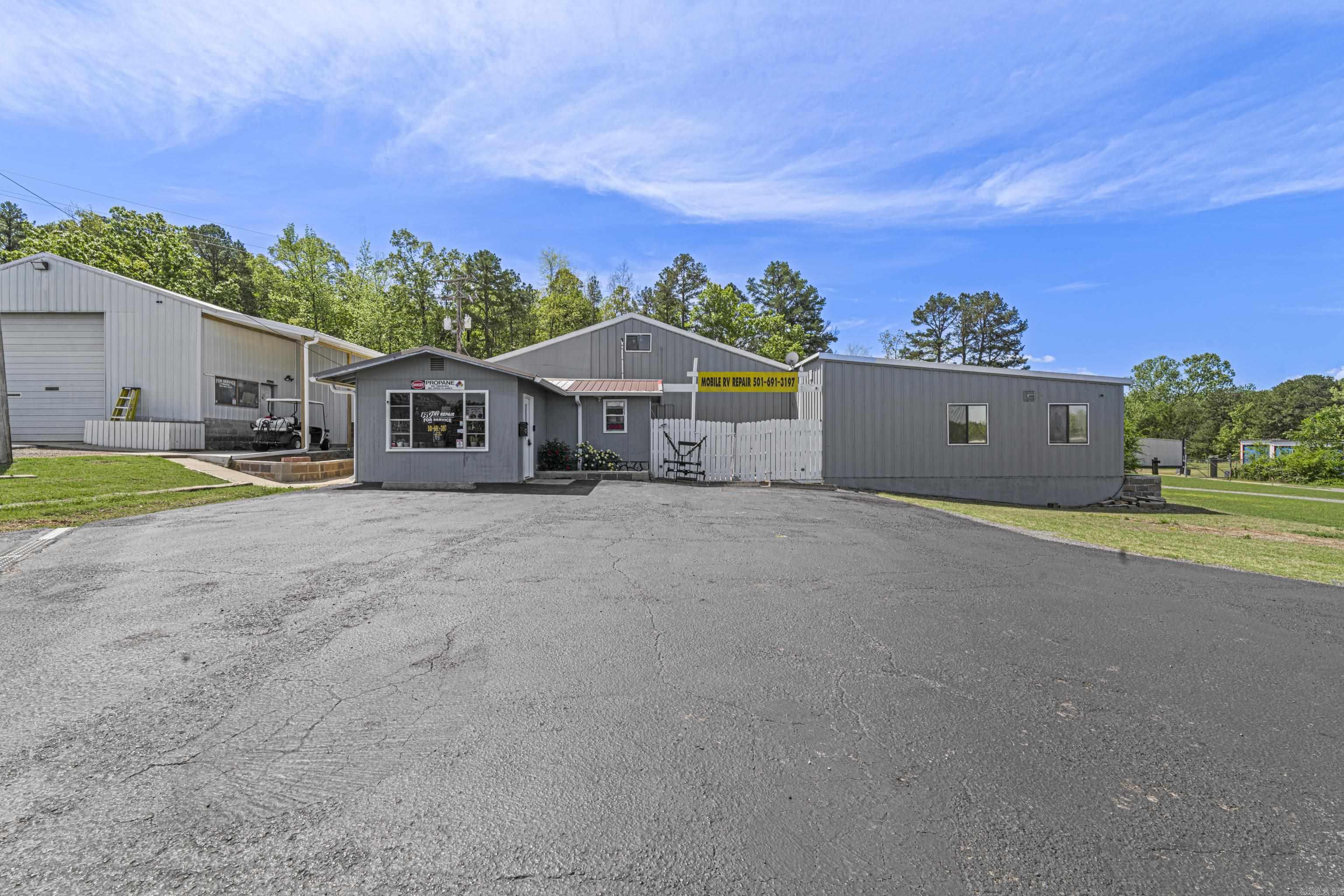 COMMERCIAL AND RESIDENTIAL!!!! Don’t miss this incredible investment opportunity in a high-traffic location near Dam Site Park and all the amenities Heber Springs has to offer. This thriving commercial property, currently operating as a successful Mobile RV Repair business, offers exceptional versatility and income potential. Spanning a total of 12,540 square feet, this well-maintained property includes: Two spacious garage bays perfect for repair or service operations. Retail storefront and office space ready for customer engagement. A large 1,920 sq ft attached apartment featuring a private entrance and a generous deck for relaxing or entertaining. Nine separate storage units, providing extra rental income. Covered parking and ample lot space for customers or business vehicles. Whether you're looking to continue the existing business or launch your own, this property is ready to go. The current business’s inventory is negotiable, making this a seamless transition for the right buyer. Take advantage of this rare find in a highly desirable location — a blend of commercial opportunity, residential comfort, and steady rental income all in one!