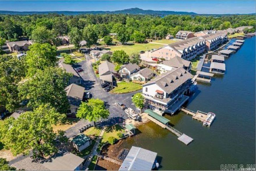 Lakefront Living Just 20 Feet from the Water’s Edge! This beautifully maintained 1-bedroom, 1-bath lakefront condo offers the perfect get away with unbeatable convenience and comfort. Enjoy your own covered boat slip with lift, making lake days effortless. Inside, you'll find a fully furnished, updated kitchen featuring stainless steel appliances and a gas stove that’s perfect for passionate cooks. The spacious walk-in shower adds a touch of modern luxury. A new pitched roof (2024) adds lasting value and peace of mind. As part of a highly desirable complex, you'll enjoy access to top-tier amenities, including: A sparkling inground pool, A large community swim deck right at the water’s edge, Private boat launch, Community lodge with a full kitchen (available for private reservations), Personal storage area for gear and lake toys, Unlimited Sonic-style ice from two large ice machines, Designated boat trailer storage. This turnkey lake condo has everything you need for relaxation, recreation, and unforgettable memories. Great Opportunity! Investment Income Potential! Can be Leased 3 months, 6 months or 12 months. Great Amenities with a Covered Dock.