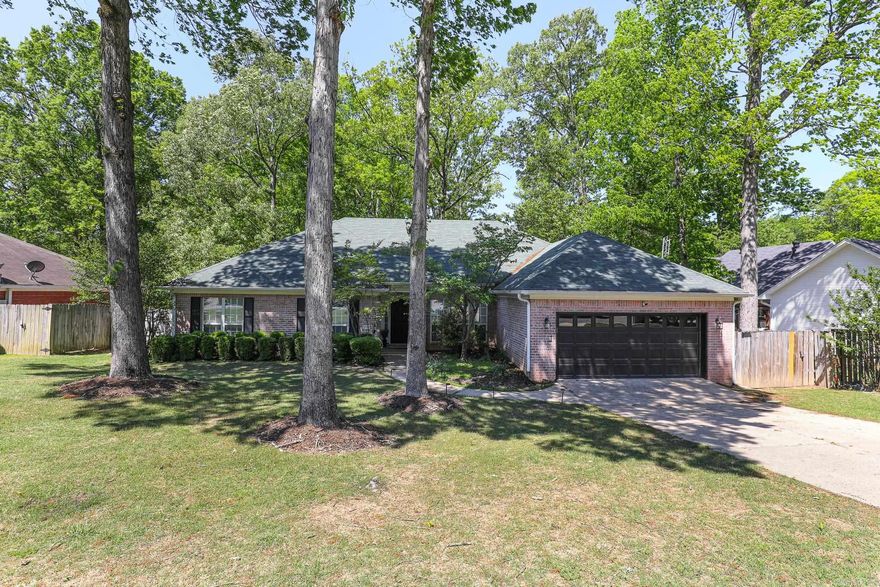 Awesome Updating! Established Neighborhood! Great Access! This home has it all!!  Beautiful updated floors, kitchen countertops, primary suite bath, brightly painted throughout, new carpet, custom fireplace and framing in great room, new blinds, gutter leaf filters, the list goes on! Spacious and open living/ dining are in this 4 bedroom, 2 1/2 baths home - Great room with cathedral ceiling features new flooring and paint, gas logs and wired surround sound. A wall of windows keeps it bright and inviting! Kitchen has granite and quartz countertops and backsplash with painted cabinets. Half bath off of kitchen for guests. Primary suite new flooring & paint and bath completely updated! New tiled Walk-in shower with a glass barn door and tiled backsplash around huge corner tub with a chandelier highlight for elegance!  Large walk-in closet for primary suite but also walk-in closets for bedrooms 2 &3! Bedroom 4 by kitchen could be an office or Gameroom! Walk out back on the enormous 2 level deck with afternoon shade! Perfect for entertaining or relaxing! Privacy fenced with another landscaped area for rest under the shade trees! Hurry!! (Garage safe room not included in price)