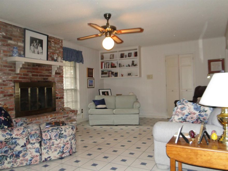 This single story brick home is located in the Mid Town area, offering 3 bedrooms, 2 full baths, living and dining rooms, den (with gas fireplace), kitchen, laundry room and a 2 car garage sitting on a corner lot (0.28 acres). Large eat-in kitchen has an electric cook top, wall oven, dishwasher and microwave. There is a free standing workshop ( with electricity) located in the fenced backyard.  Side-load garage also offers a work shop area. Refrigerator, washer & dryer convey at no value. Sold "as is"