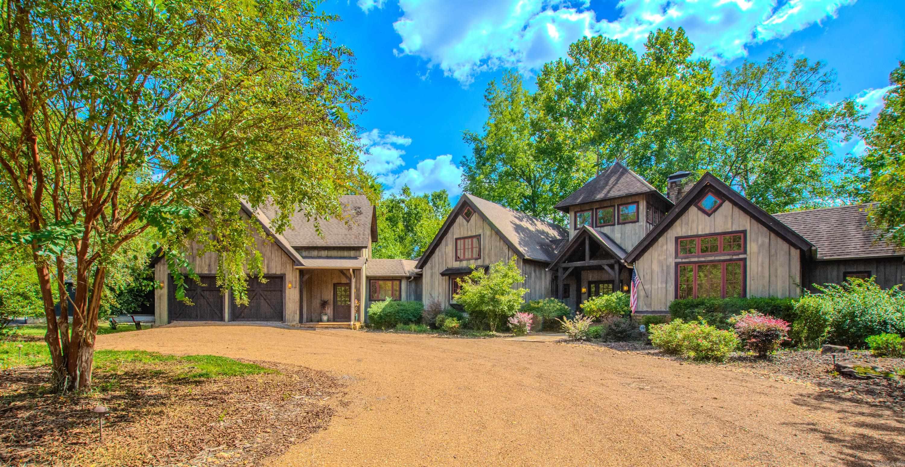 This spectacular home on the Little Red River is located in the gated community of Primrose Creek. The stunning entrance opens into a towering foyer, leading into the grand open-concept living room, kitchen and dining room. Cathedral height wood ceilings with Mill Creek Design Post and Beam construction, a stone fireplace, and a full wall of windows provide breathtaking views of the river. The custom kitchen features handcrafted cabinetry, granite countertops, and professional-grade Thermador appliances for a commercial grade chef's kitchen. The home offers three generous bedrooms, including a serene primary suite. Relax year-round in the screened porch with its own stone fireplace. Outdoors, the property boasts extensive shore stonework and a private boat dock for easy access to world-class trout fishing. This home is being sold fully furnished, ready for immediate enjoyment. Primrose Creek offers a private community pool and gathering area, just minutes from Greers Ferry Lake, a fishing pond, and scenic hiking trails. With access to all the beauty and adventure the Natural State has to offer, your dream home is only a step away. Let us help make it a reality