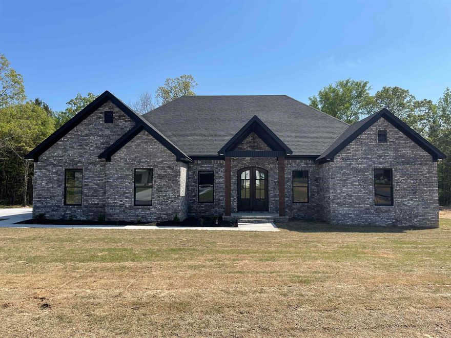 Welcome to this stunning new construction home in the highly sought-after Greenbrier School District! This 4-bedroom, 2-bath home offers over 2,300 square feet of living space on a spacious 1-acre lot. Enjoy privacy with a backyard that backs up to peaceful woods. The all-brick exterior provides timeless curb appeal, while the covered patio is perfect for outdoor relaxation. Inside, you’ll find custom cabinetry and gorgeous granite countertops in both the kitchen and bathrooms. The primary suite features a luxurious custom tile shower, soaking tub, and double vanities. The home also boasts luxury vinyl plank flooring throughout and an electric on-demand hot water heater for endless hot water. The spacious living room, complete with an electric fireplace, is ideal for cozy evenings. Plus, the side-entry garage adds both convenience and style. This home combines elegance, functionality, and privacy in a prime location! Don't miss out! Come see this home today!