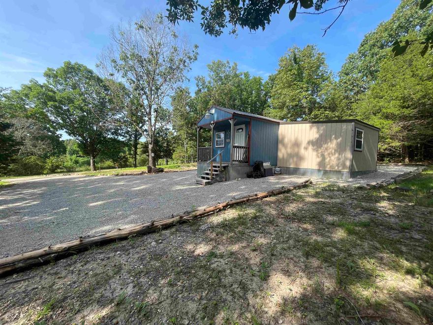 CHRISTMAS SPECIAL!!  New FIRM Price of $62,500  Check out this charming 400 sq ft cabin nestled on 2.43 unrestricted acres in the beautiful Ozarks — the perfect blend of comfort, convenience, and flexibility! Whether you're looking for a cozy home base, weekend retreat, or RV-friendly setup, this property has you covered. Upgrades & Utilities Galore: Two water meters  Electricity on site, plus plug-in at the pole  New 1000-gallon septic tank 30 & 50 amp electric RV hookups and an RV sewer hookup– bring your camper or tiny home!  Reem hot water heater  Rockwool mineral wool insulation for energy efficiency  All PEX water lines run inside the cabin – no freezing worries!  High-speed fiber internet – work remote or stream with ease The land is surveyed and unrestricted, giving you the freedom to build, expand, garden, or just relax under the stars. Rural water access adds even more peace of mind.  Priced to sell at $62,500 – a rare find with this much potential and infrastructure already in place! Don’t miss out – schedule your private showing today and start living your country dream!