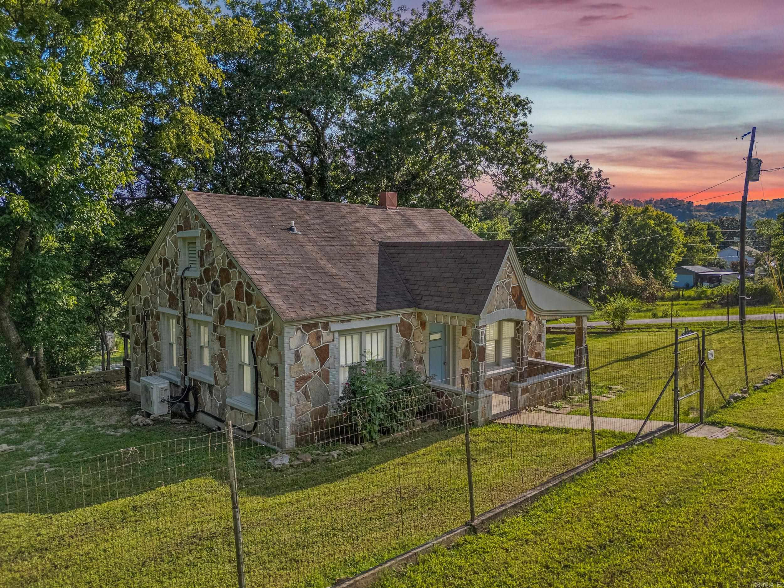 Nestled in the cozy Rivertown of Norfork. This tastefully updated two-bedroom, one bath home offers charm, comfort, and an unbeatable location. Just minutes from the confluence of the White and North Fork Rivers, it's a dream retreat for outdoor lovers. Enjoy the warm, inviting feel of a cabin or cottage, complete with al appliances, a fenced yard, and a spacious back deck perfect for relaxing or entertaining. The corner lot offers added space and privacy, plus a detached storage building/workshop for your hobbies or gear. NEXT fiber optic is available for fact connectivity makes this home ideal for full-time living or a weekend getaway.