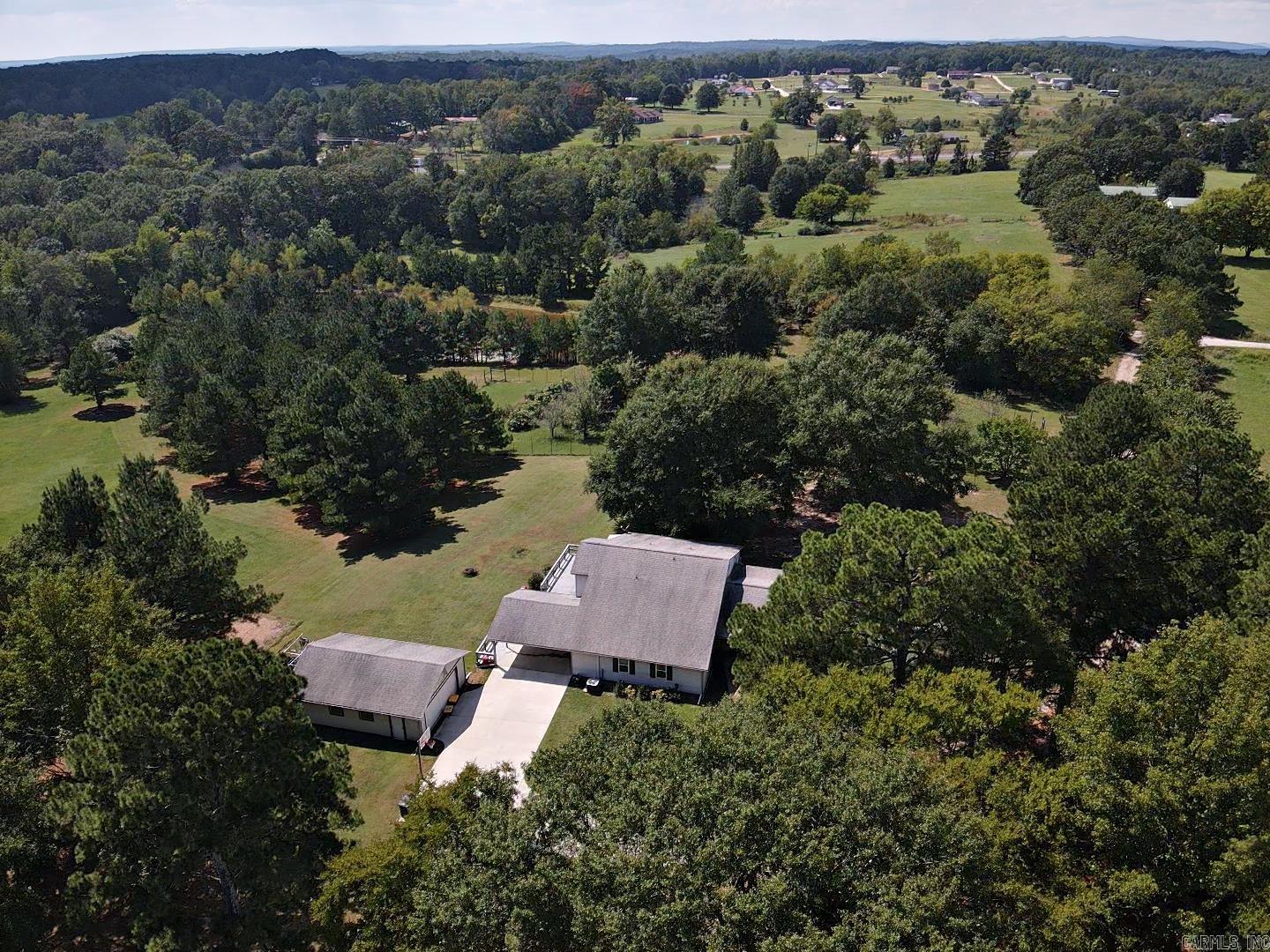 This up-to-date modern farmhouse features 4 bedroom and 3 full baths, and many extras. The kitchen, dining room and living room are all arranged in an open floor plan with granite counter tops and stainless appliances in the kitchen. There is plenty of room for an office separate from the bedrooms. Outside, the 2 car detached garage sits seconds away from the 2-car covered carport. A separate workshop has lots of storage space and places for tools, boats and 4-wheelers. There is also a Generac generator, fenced orchard/garden area, stock pond, chicken coop and barn on the acreage. Don't miss out on country living at its best!