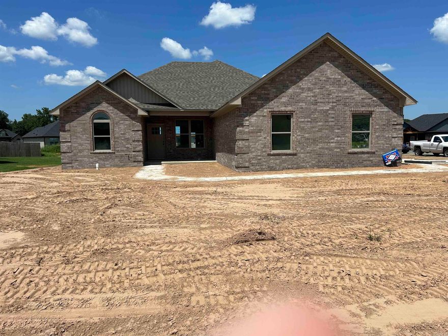 Another custom built home by long time onsite builders ,Three bedrooms on nice corner lot with side loading garage that opens into a custom storage area for shoes cloths and cabinet good side laundry room super large master bedroom with private spa like bath large soaking tub double vanity sinks and plenty of closet space .Open den kitchen dining area with pantry bar overlooks and built in fireplace heatalater for cool winter nights .Split bedroom plan with nice size rooms .LUXURY vinyl floors thur out covered patio in back with a view of the lake .