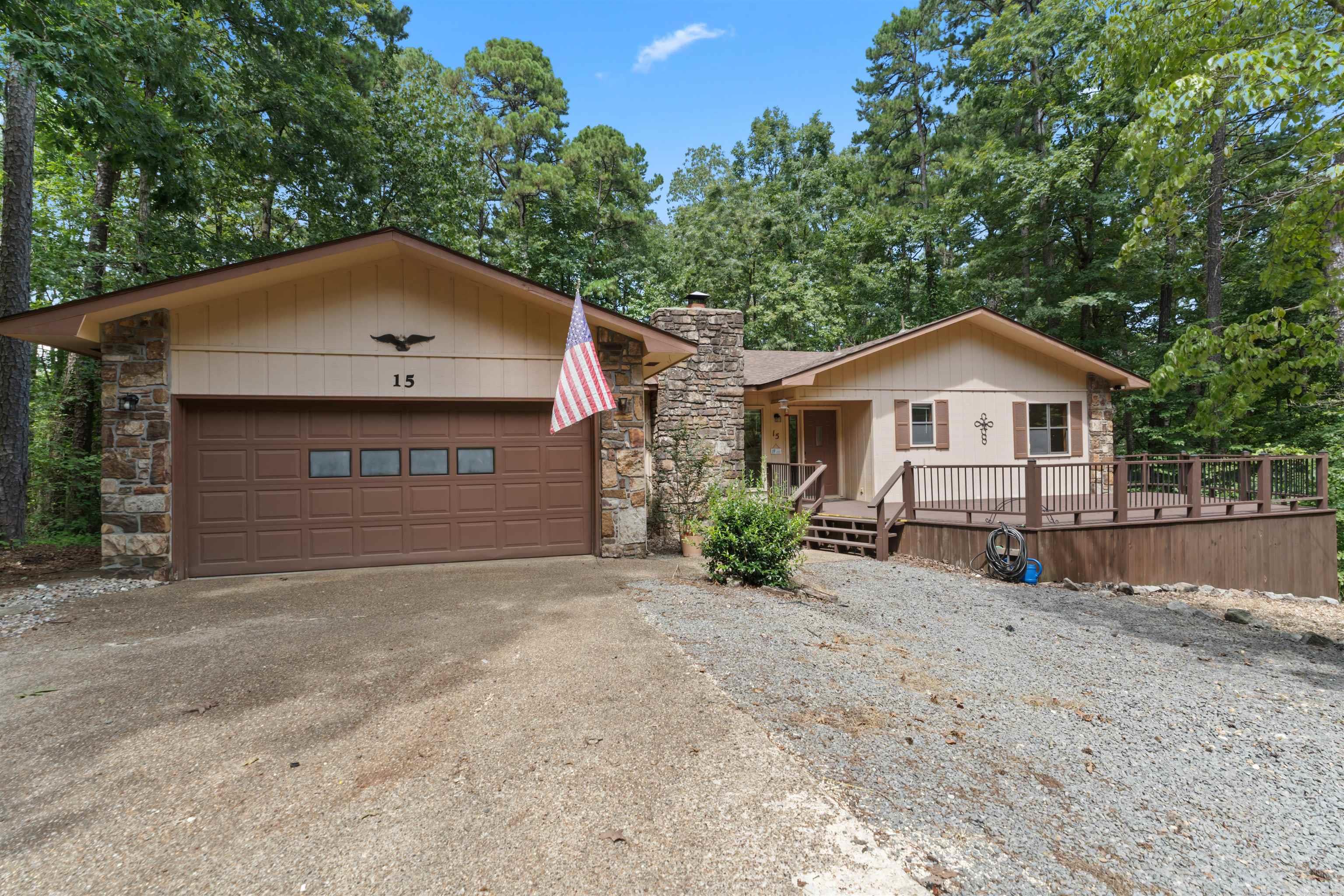Charming home on a quiet cul-de-sac in Hot Springs Village. This property features mature trees, a spacious front deck, and a fenced yard perfect for pets. Inside, enjoy a cozy living area with a fireplace and wood-beamed ceiling, plus a heated and cooled Arkansas room for year-round use. Floor plan offers 2 bedrooms and 2 baths, along with a flex room that can serve as an office, laundry room, or additional bedroom. Kitchen has updated stainless steel appliances. Both bathrooms have been updated. 2 car garage with room for extras! Roof replaced 2022. Convenient location with privacy and plenty of space to make it your own!