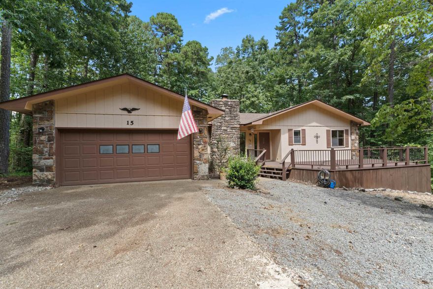 Charming home on a quiet cul-de-sac in Hot Springs Village. This property features mature trees, a spacious front deck, and a fenced yard perfect for pets. Inside, enjoy a cozy living area with a fireplace and wood-beamed ceiling, plus a heated and cooled Arkansas room for year-round use. Floor plan offers 2 bedrooms and 2 baths, along with a flex room that can serve as an office, laundry room, or additional bedroom. Kitchen has updated stainless steel appliances.  Both bathrooms have been updated. 2 car garage with room for extras!  Roof replaced 2022. Convenient location with privacy and plenty of space to make it your own!