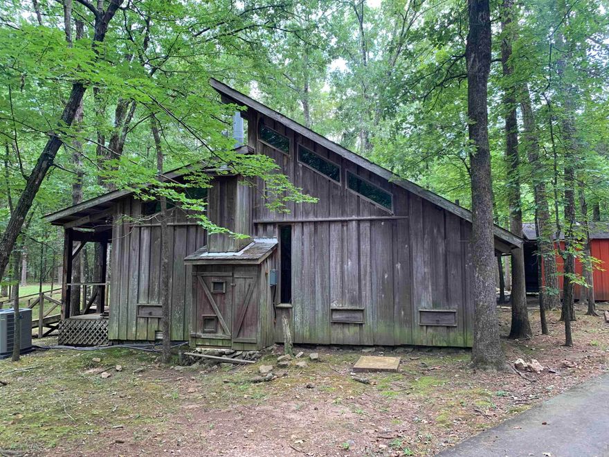 This live / work property offers a quiet and secluded setting with exceptional flexibility.  This property's strategic location offers great connectivity and accessibility.  1,100 s/f rustic cabin sitting on 5.65 acres of land.  Wood-burning fireplace, creating a warm and functional space suitable for residential, creative or office use.   Also available 18209 Cantrell which is an adjoining 1.51 acres with 2,484 s/f Prairie Style home, inspired by Frank Lloyd Wright.  3 bedrooms, 2 baths, large bonus room.  Listed for $925,000.00  Both properties can be purchased together for a discounted price of $1,950,000