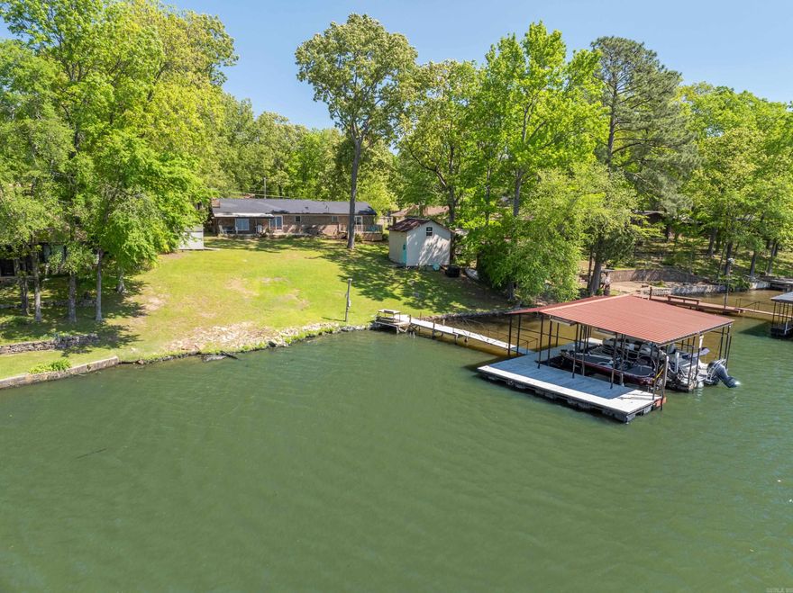 Welcome to your lakeside paradise! This charming 3 bedroom, 2 bath home on Lake Hamilton offers comfort and tranquility. Enjoy an open floor plan, fireplace, and updated kitchen. Outside, discover a spacious yard, two outdoor storage rooms, and a covered 2 stall boat dock with a lift and a swim platform. Perfect for fishing, boating, or simply enjoying the gorgeous view. Additionally, situated outside the city limits, this home presents an ideal opportunity for short term rental use when the owner isn't utilizing it personally, with no permit required. Schedule a showing today!