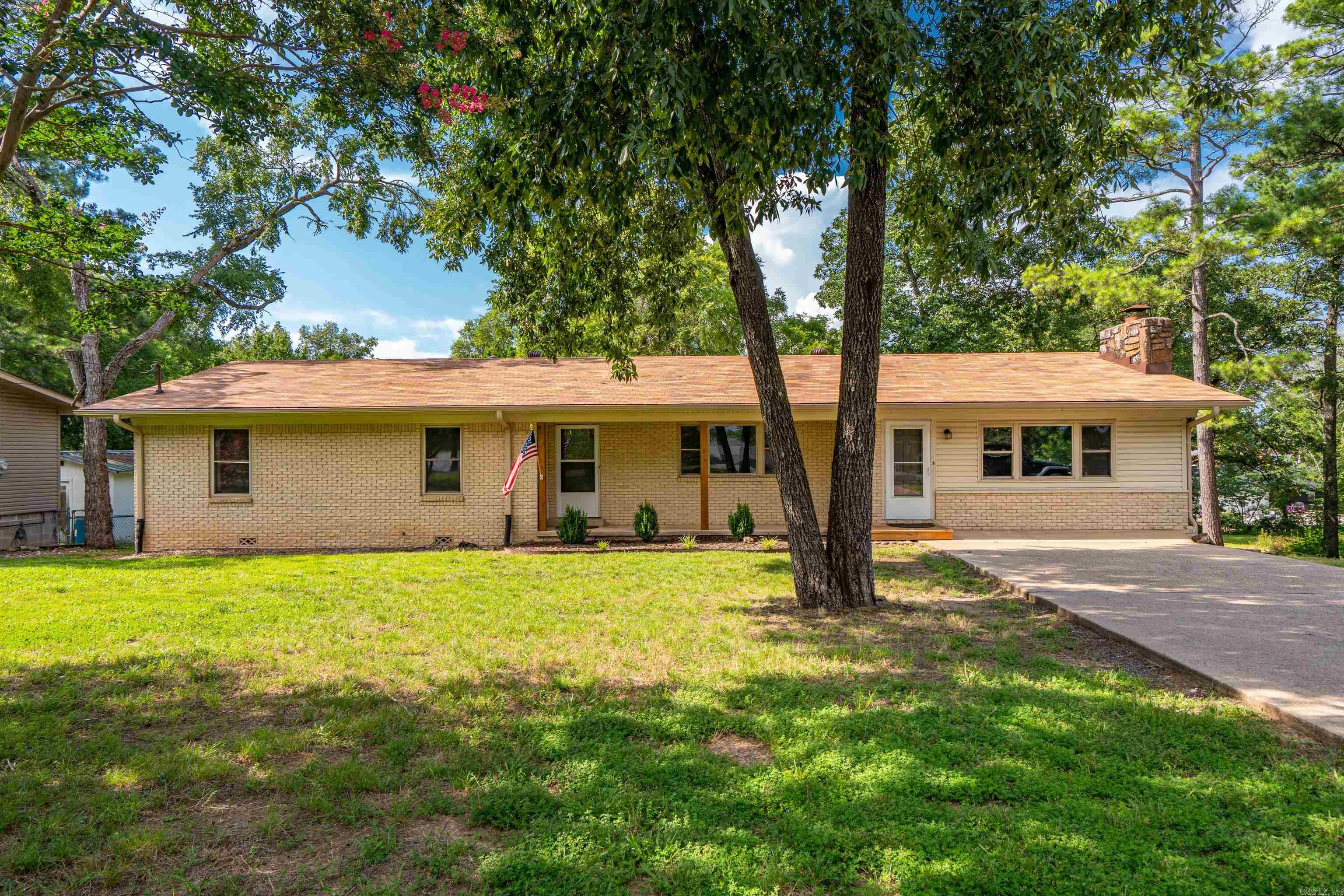 Don’t miss this freshly updated ranch with Lake Hamilton frontage in Lakeside School District, PRICED UNDER $150 per sq ft! Updates include new roof, fresh paint throughout, refinished hardwoods, LVP, new custom shower, new stove, and insulated windows. Enjoy playing and gardening in the XL backyard. Spend your afternoons fishing from the bank of Lake Hamilton and your evenings relaxing by the fire. The walk-in level hosts nearly 2,100 sq ft of everyday living space including the home’s 3 bedrooms and 2 bathrooms, living room, dining room, oversized kitchen, sitting area, and laundry room. Downstairs is a clean slate of 2 rooms ready for use as a game room, office, media room, craft or home-schooling space, etc. The backyard is HUGE and ideal for a garden, pets, and kiddos to play. So many options and so many memories to be made! This is a big “bang for your buck!”