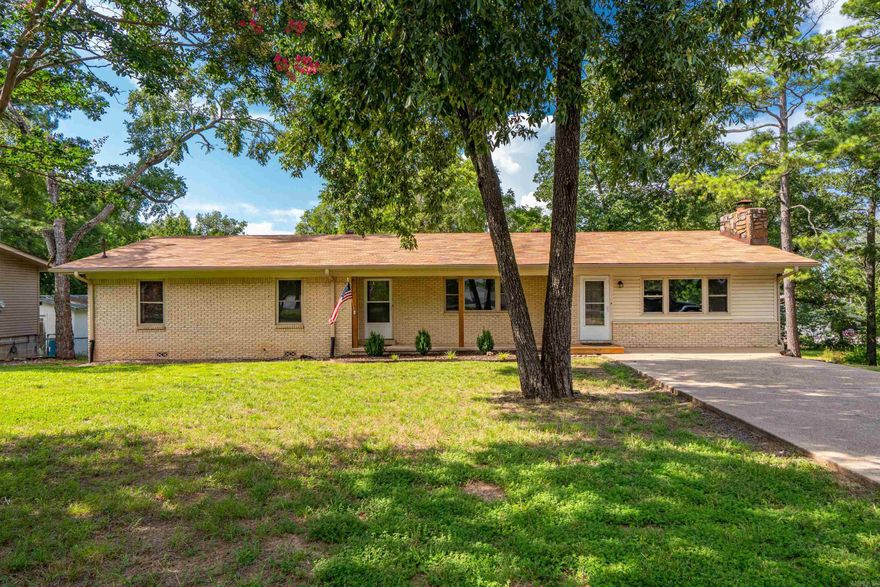 **SATURDAY OPEN HOUSE to launch price reduction to $350k. Join us 1:00-4:00 this Sat., Oct 11th.**  Don’t miss this freshly updated ranch with Lake Hamilton frontage in Lakeside School District, PRICED UNDER $150 per sq ft! Updates include new roof, fresh paint throughout, refinished hardwoods, LVP, new custom shower, new stove, and insulated windows. Enjoy playing and gardening in the XL backyard. Spend your afternoons fishing from the bank of Lake Hamilton and your evenings relaxing by the fire. The walk-in level hosts nearly 2,100 sq ft of everyday living space including the home’s 3 bedrooms and 2 bathrooms, living room, dining room, oversized kitchen, sitting area, and laundry room. Downstairs is a clean slate of 2 rooms ready for use as a game room, office, media room, craft or home-schooling space, etc. The backyard is HUGE and ideal for a garden, pets, and kiddos to play. So many options and so many memories to be made! This is a big “bang for your buck!”