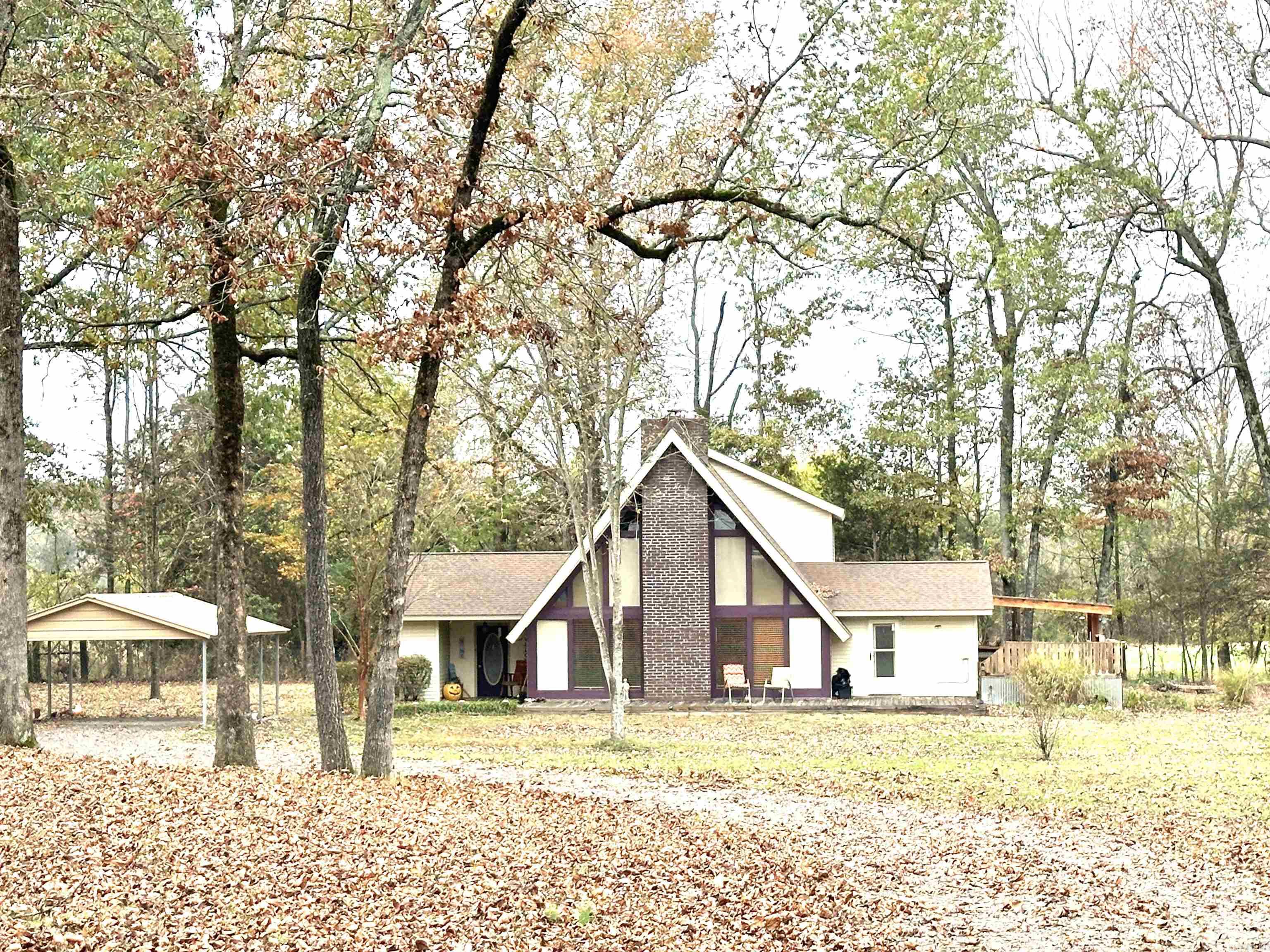 Welcome home to this unique and inviting A-frame style retreat, perfectly set on 3.23 scenic acres. With 3 bedrooms, 2.5 baths, and thoughtful design throughout, this property offers the ideal setting for your family to thrive. The heart of the home is the expansive living room, where towering windows frame picturesque views, fill the space with natural light, and create an unforgettable ambiance. Gather around the cozy fireplace on chilly evenings, making it the perfect spot for family movie nights or quiet relaxation. The spacious kitchen offers abundant storage and functionality, while upstairs, two bedrooms and a full bath provide a cozy retreat. Kids will love exploring the open yard, while the large double-bay shop and storage building provide endless possibilities.