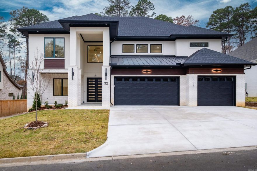 Welcome to 32 Mereville Place, a beautifully designed home still under construction—giving buyers the exciting opportunity to choose their elaborate finish-out, including flooring, paint, and fixtures. Centrally located next to The Promenade at Chenal, this home offers convenience, elegance, and custom potential all in one.  Enjoy two covered front porches—both upper and lower—for charming curb appeal and relaxation. A large sliding door off the kitchen and living room opens to the backyard, perfect for entertaining. Inside, you’ll find a media room and bonus room, providing ample space for large or growing families.  The primary suite and a secondary suite are both located on the main level, thoughtfully designed with a split layout for added privacy. An oversized three-car garage offers abundant storage and parking, and a small greenbelt buffer adds a touch of nature to the backyard. All of this is nestled in a secure, gated subdivision.