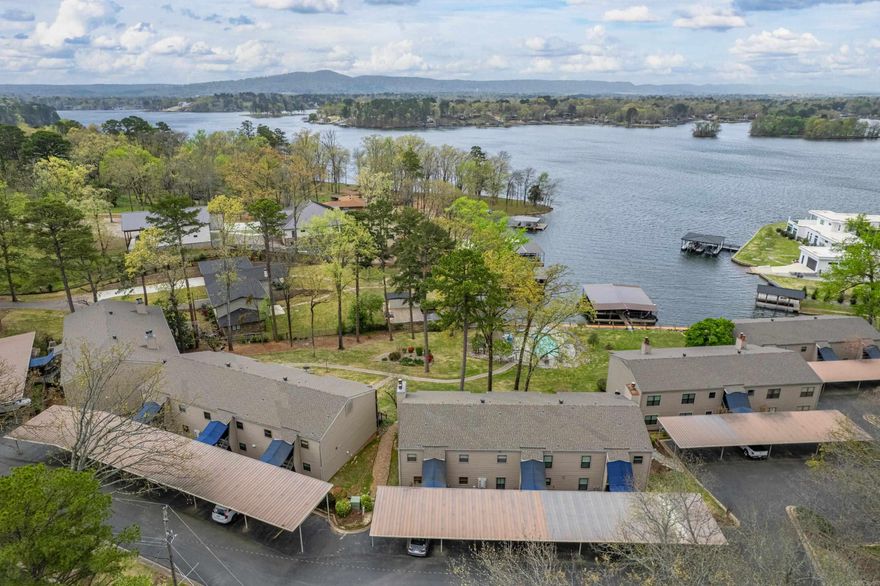 Enjoy the best of lakeside living in this beautifully maintained 2-bedroom, 2-bath condo on Lake Hamilton! Take in stunning water views from your private balcony, and unwind in the spacious primary suite featuring a giant walk-in shower, double sinks, and a generous walk-in closet. The separate dining room offers the perfect space for entertaining, while the open layout creates a warm and inviting atmosphere. This lakefront community also includes access to a shared pool—ideal for relaxing or hosting friends. Whether you're looking for a permanent home, a weekend retreat, or an investment opportunity, this gem has it all!