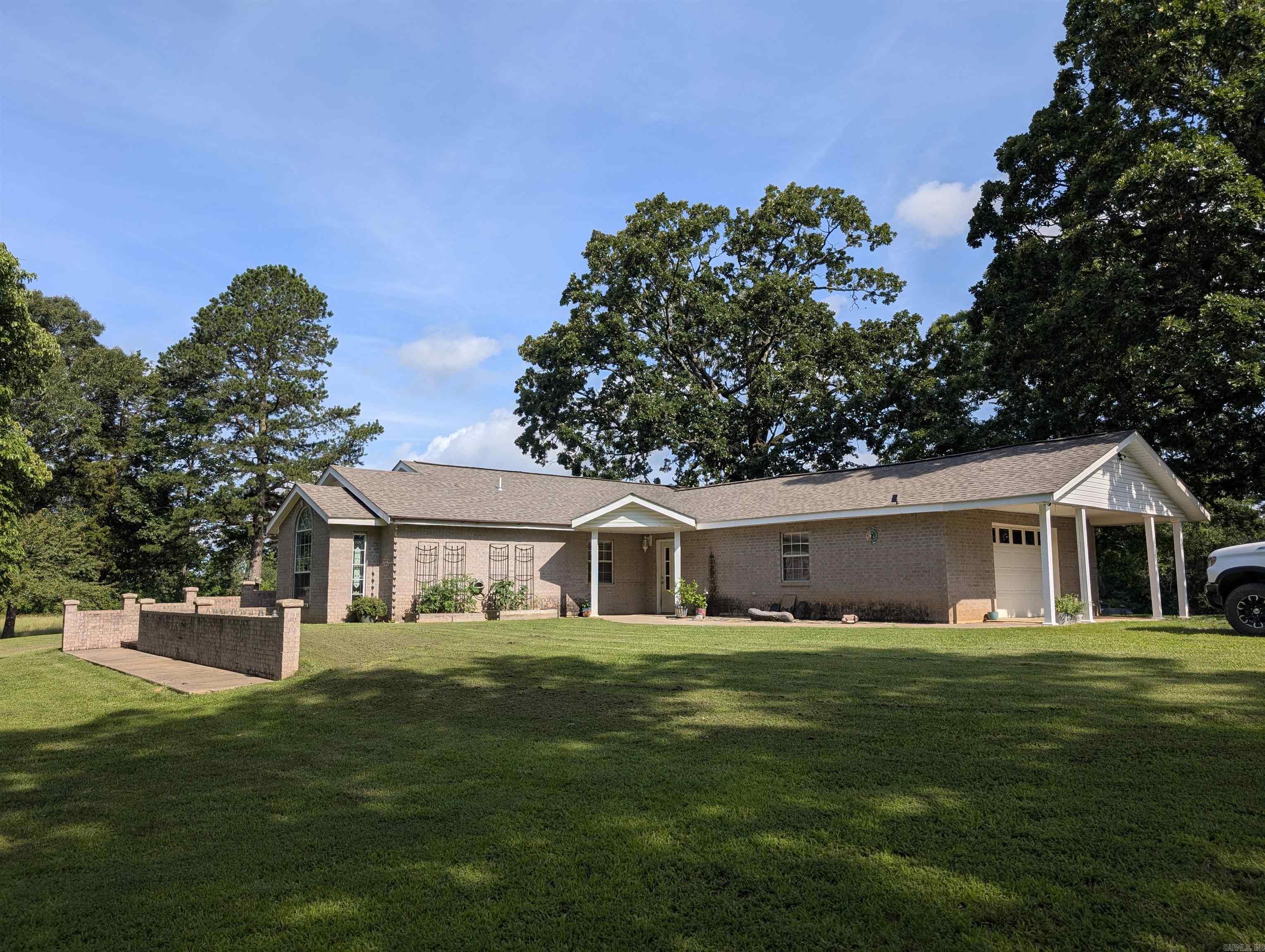 Experience country living at its finest in the charming 3/2 brick home nestled on 20 acres of picturesque land. The two car garage is heated and cooled. Enjoy mountain views, two spring fed ponds, surrounded by lush fruit and nut trees. This property also features a convenient carport and shop. A section of the land has been fenced for animals and has a water hook up for easy watering. Donāt miss this unique opportunity to own your private retreat!