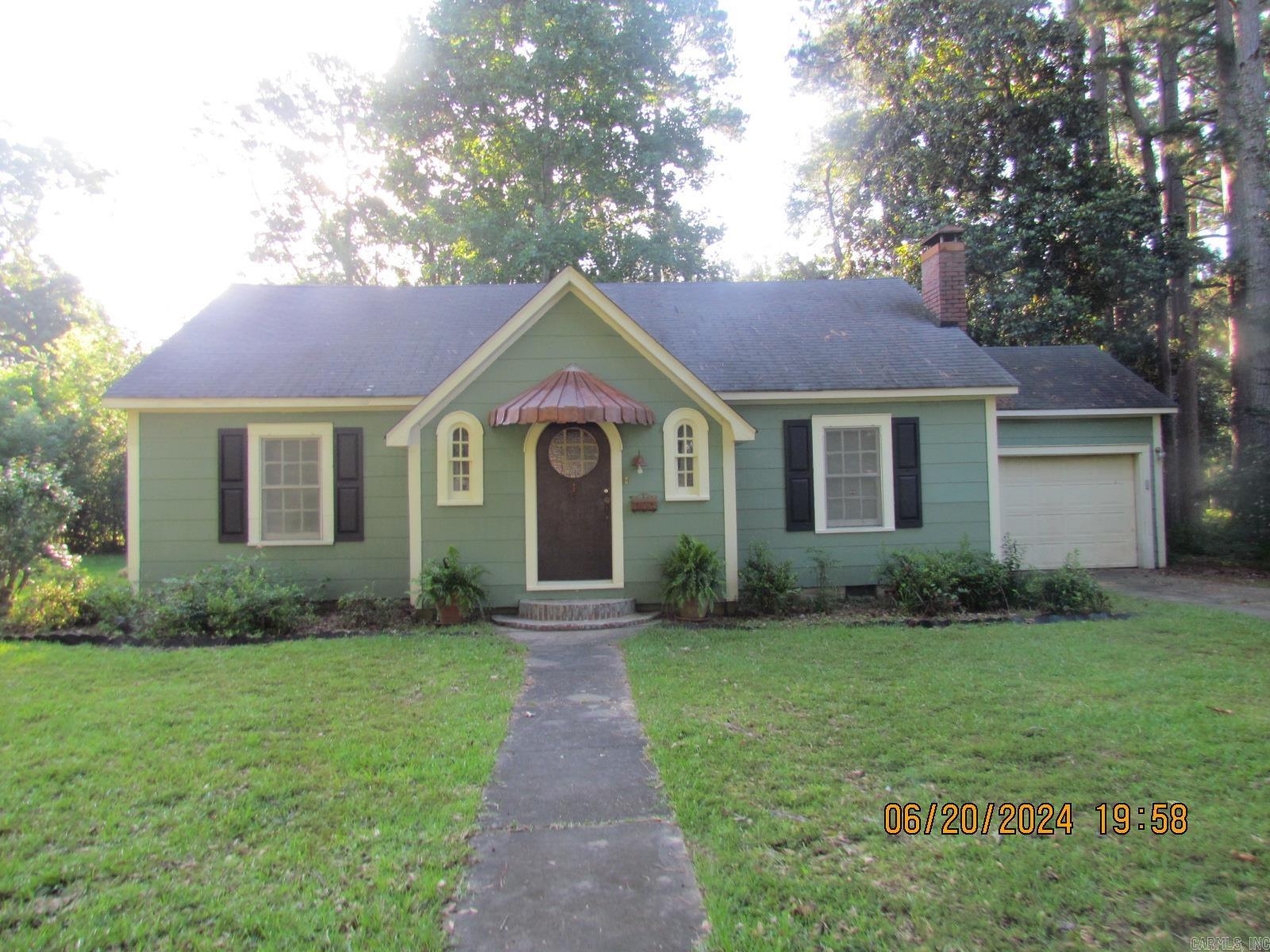 Charming Cottage sitting on .35 acres in Crossett featuring a beautiful entry, a large living room with fireplace, a charming dining room, a galley kitchen, a remodeled bathroom with shower over the bathtub, two charming bedrooms with closets. This charming home has been remodeled and waiting for you. Beautiful new lighting installed, beautiful wood floors, new carpet in both bedrooms, two window units and a infared heater, laundry room in the garage, and storage shed in the large backyard.