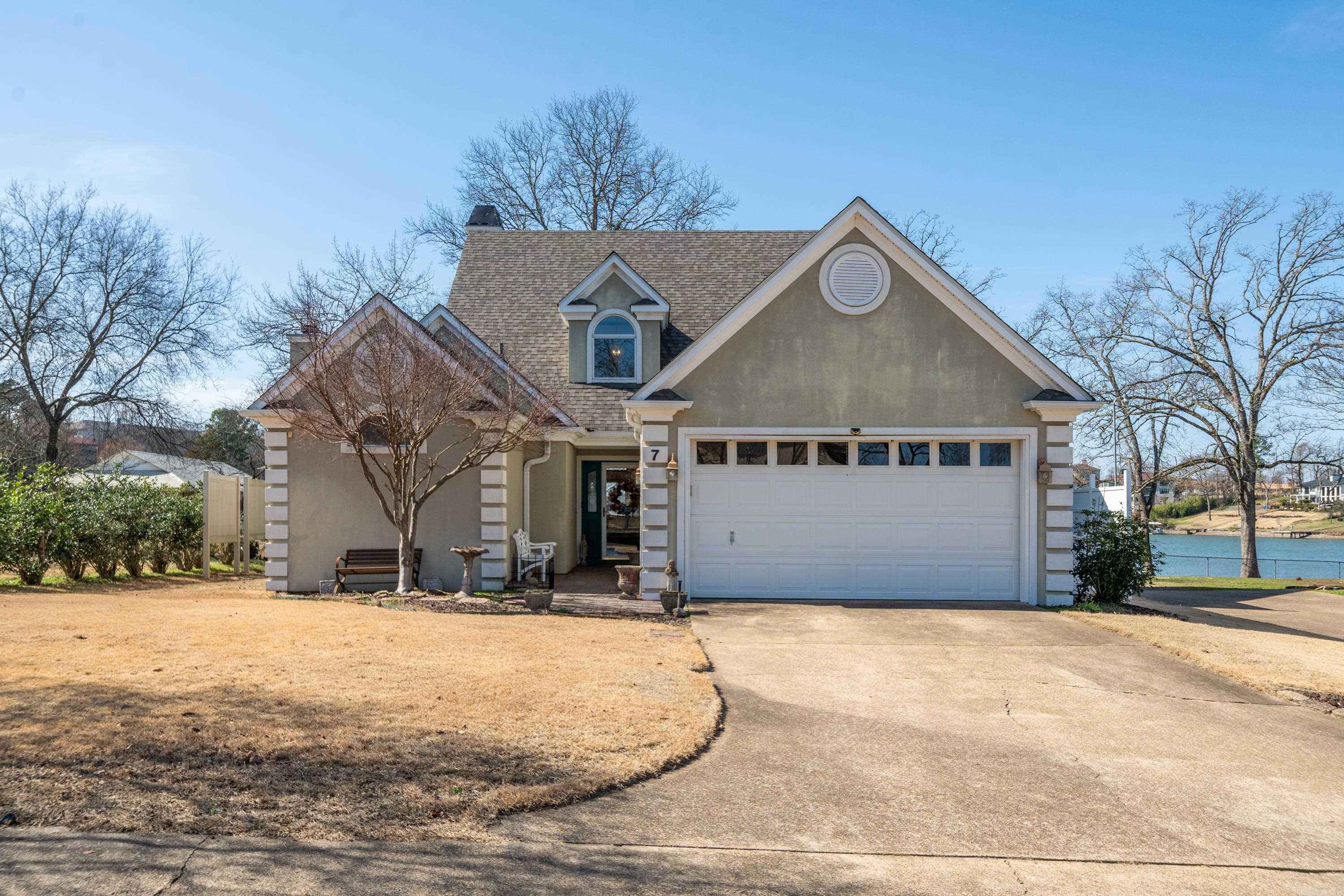 Experience lakeside living on Lake Hamilton in this lovely home offering spectacular water views from multiple vantage points. Set behind a gated entrance for security and peace of mind. The primary suite is conveniently located on the main floor, featuring a walk-in glass shower, a luxurious Jacuzzi tub, and a spacious walk-in closet. The kitchen is complete with stainless steel appliances, a gas stove, granite countertops, and ample storage. Cozy up by the gas-log fireplace inside, or enjoy year-round outdoor living with a screened-in porch featuring a wood-burning fireplace and a covered patio—both offering serene lake views. The home also boasts a garage, a sprinkler system, and a boat slip, and 1/2 of the waterfront Lot 8 that adjoins the property, making it the perfect waterfront getaway. 1 year Home Warranty offered.