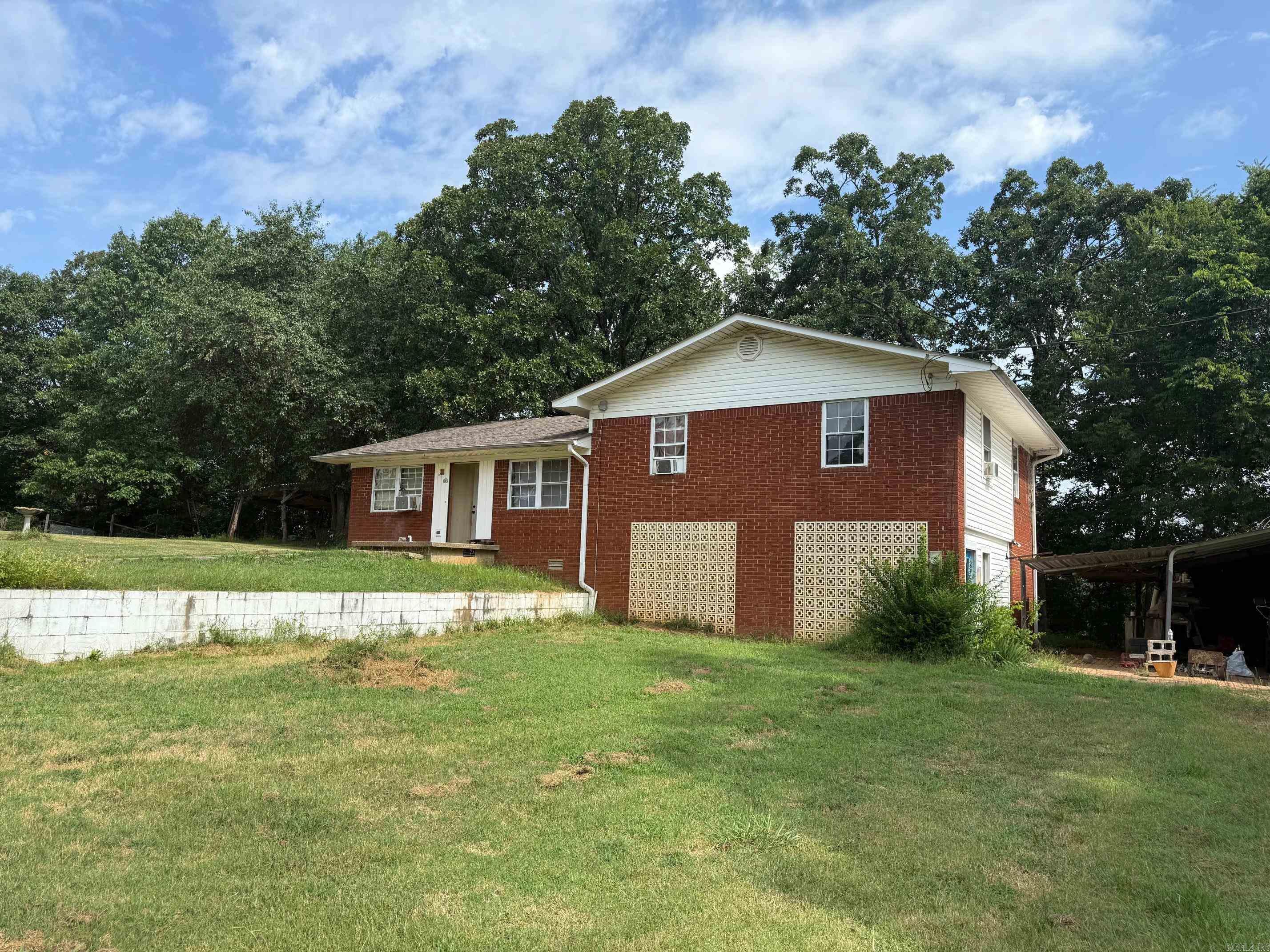 This property sits in a great neighborhood and minutes from Lake Catherine and Hot Springs. This is a fixer upper with great potential for investors or the family. The split-level offers living room/dining room combo, kitchen, 2 bedrooms and full bathroom, the lower level has a bonus room possible bedroom, a full bathroom and workshop all sitting on 1.32 acres. A metal carport sits beside the house. This is a great opportunity, call today for a showing. Property is sold "as is."