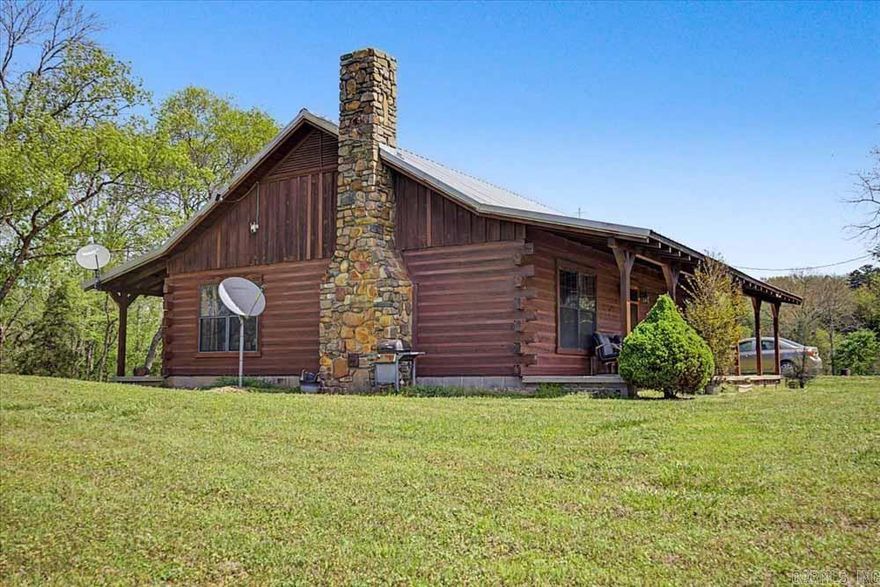 ONE OF A KIND! Rustic Log Cabin home with a covered porch on 25.78 acres near Mena, Arkansas with a woodburnings stove, 1200 square foot barn, a 2800 utility building, a pond, plus three small utility buildings. and a creek running alongside of the back of the property. The land has 882' of highway frontage and is about 1/3 timber, and 2/3's cleared area for agriculture (Pasture and/or crops).    It's less than 10 minutes from shopping and dining in Mena and Hackett.  This is your opportunity to live in scenic Western Arkansas in a beautiful log cabin, where you can sit back and relax or to raise some cows and horses and enjoy some gardening.  The choice is yours, so call the listing agent today to make an appointment to view this property in person.