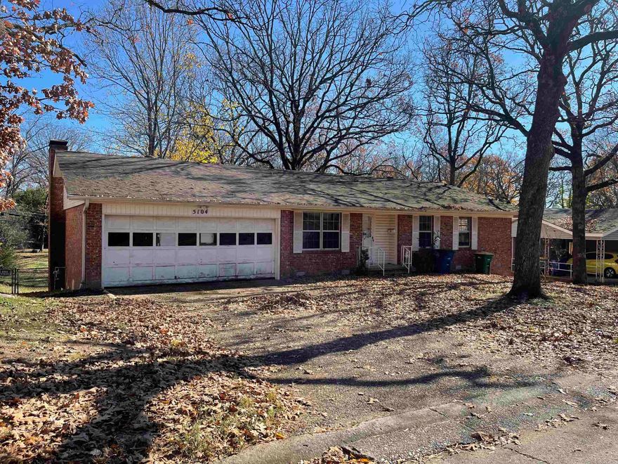 All brick home with LOTS of potential and EXCELLENT location just off of JFK! This 3 bedroom, 2 full bath home features a 2 car garage, 2 living areas, a large dining room, and a wood burning fireplace.  This home also features a large 1,100 sq ft basement with electricity for shop, workspace, or extra storage as well as a 2 story back deck in the fully fenced large backyard.  Come check this one out and make it your own! Home is being sold AS IS.