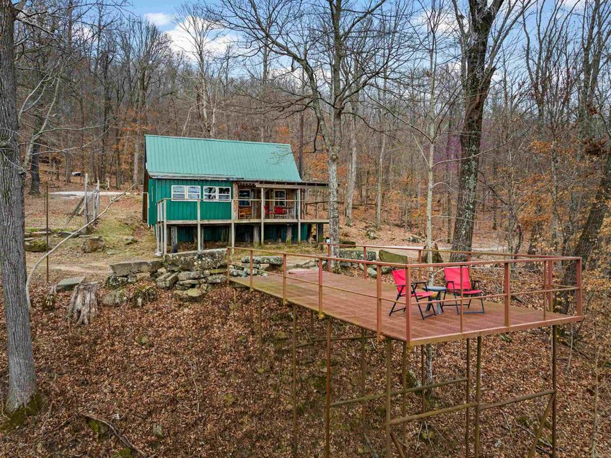 These breathtaking cabins are a do not miss! Tucked away in the Ozark Mountains with beautiful views just outside the front door of these rustic cabins. Two cabins on over 25 Acres, with many places to expand and add additional. Horse stall, storage building, and a firepit this property has it all. Currently being used for nightly rentals as a flourishing business all media platforms will convey.