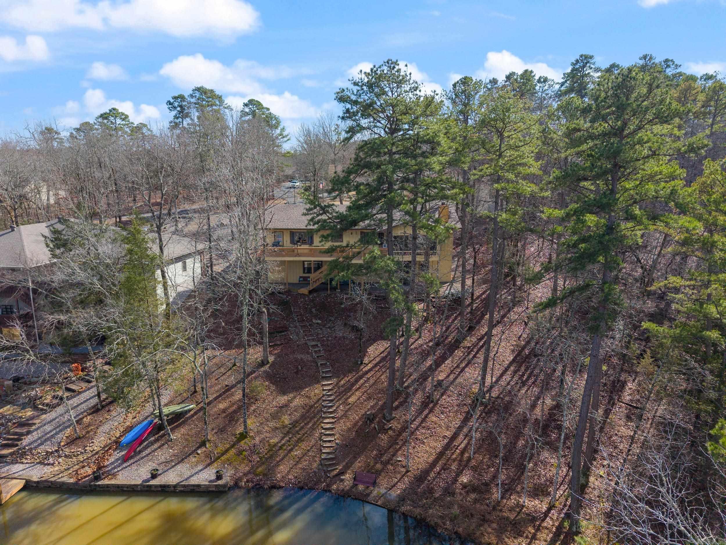 Waterfront living on Lake Pineda with a new roof (1/30/25)! This home has large rooms with new flooring throughout. On the top floor, enjoy stunning lake views from the den, dining area, kitchen, breakfast nook, and utility room. The basement includes a generously sized bedroom that can easily fit 2-3 Queen-sized beds, also with lake views. The expansive game room, perfect for a man cave or potential apartment, offers more lake views and is ideal for entertaining. Additional highlights include a wood-burning fireplace, an oak kitchen with a huge pantry, and sleek Quartz countertops. The third bedroom in the basement has its own full bath, making it a potential dual unit or VRBO, AirBnb, short-term rental. Fresh new tile flooring downstairs adds to the home’s appeal. The total living space is 3,021 sq ft, including the downstairs game room (note: the 160 sq ft Arkansas Room is not included in this measurement). Enjoy your backyard by kayaking, fishing, or cruising on a pontoon boat! The property also features a greenbelt on one side for extra privacy, creating a serene and peaceful setting. Recent updates include: new tile shower, all new HVAC,flooring, stove, paint, and much more!