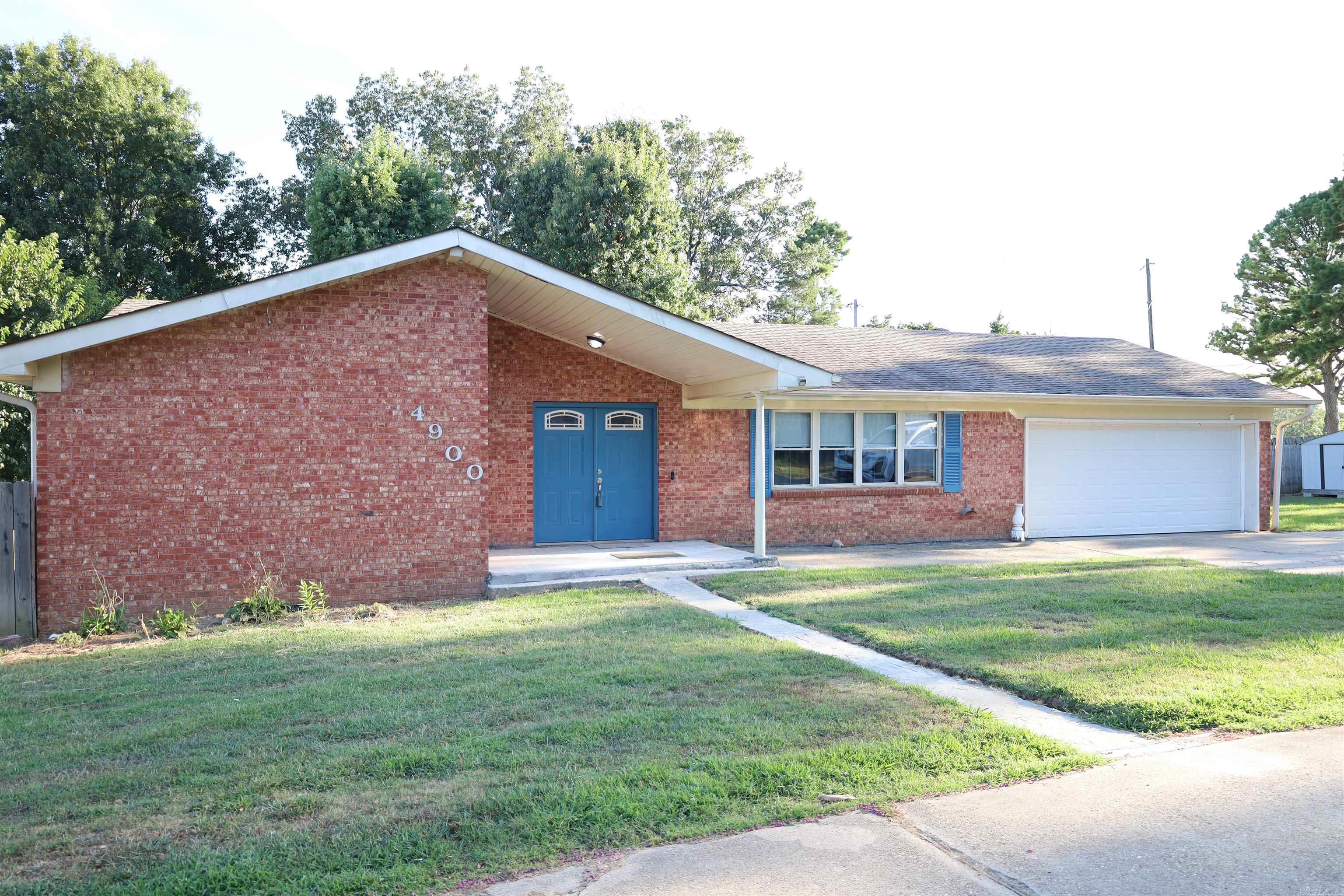 Discover this delightful brick home nestled in a peaceful Paragould neighborhood West of town. The large, open family room boasts new flooring that extends throughout the main level. The eat-in kitchen, adjacent to the family room, is well-appointed with granite countertops, abundant cabinetry, breakfast bar, and stainless steel appliances. The spacious primary suite includes a private bathroom, while two additional bedrooms and another bathroom are also located on the main level. The finished walk-out basement offers versatile living spaces, including two living areas and a bathroom. Recent updates include new flooring upstairs and downstairs, new plumbing, a new toilet downstairs, built-in bookcases, and a fifth bedroom addition. With a newer sump pump, dishwasher, and stove, this charming home is perfect for first-time buyers. Don't miss this gem at 4900 McPhill Drive, Paragould, ARāpriced at $240,000!