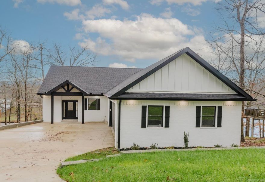Spring is almost here and this beautiful new construction comes with a COVERED BOAT DOCK and is complete and ready! Water views from every level and spacious 4 bedroom, 3.5 bath will accommodate all your guests. Downstairs is perfect for entertaining and has a living area, two bedrooms, a bunkroom and two full baths. Main level holds the open concept living/kitchen/dining areas as well as the primary bedroom/bath, laundry room and 1/2 bath at entryway. Enjoy the outside from both levels on the full length covered porches. Premium luxury vinyl plank flooring, quartz counter tops in the kitchen, granite in the other wet areas and a place to hang your bags, coats and other items as you enter the home from the garage. And did I mention the large laundry/pantry combination? It's oversized with a lot of custom cabinets. We can get this one closed in time for you to enjoy the views and the lake this summer! Whether you are looking for a personal home or a short term rental, this beauty may be the one! See agent remarks.