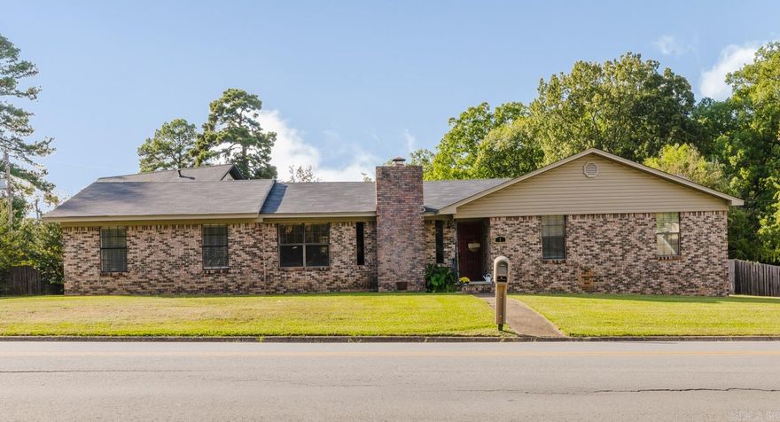 Beautiful all-brick home in the heart of Bryant sitting on over 1/2 of an acre! This well-maintained property offers numerous updates including a new roof (2024), new furnace (2024), hot water heater (2022), and new luxury vinyl flooring in the main living areas and kitchen (2024). Fresh paint throughout with new baseboards, crown molding, light fixtures, and ceiling fans give the home a modern feel. The spacious living room features a vaulted ceiling with wood beams and a charming brick fireplace with a wood-burning stove. The large kitchen offers abundant cabinet space, a built-in desk, pantry, dining area, and a new dishwasher (2024). The primary suite includes a walk-in closet, double sinks, and a walk-in shower. Outside, enjoy the newly added covered back deck overlooking a huge fenced yard—perfect for entertaining or family time. Additional features include a side-loading garage, large storage room, and excellent location near Bryant schools, parks, and shopping. Close to Reynolds Road and the interstate for an easy commute!