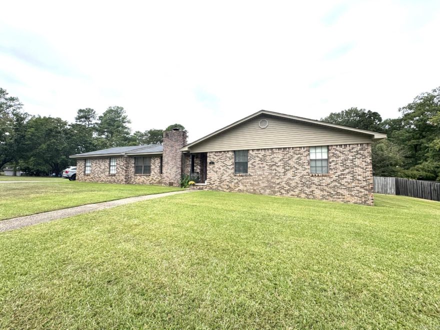 Beautiful all-brick home in the heart of Bryant sitting on over 1/2 of an acre! This well-maintained property offers numerous updates including a new roof (2024), new furnace (2024), hot water heater (2022), and new luxury vinyl flooring in the main living areas and kitchen (2024). Fresh paint throughout with new baseboards, crown molding, light fixtures, and ceiling fans give the home a modern feel. The spacious living room features a vaulted ceiling with wood beams and a charming brick fireplace with a wood-burning stove. The large kitchen offers abundant cabinet space, a built-in desk, pantry, dining area, and a new dishwasher (2024). The primary suite includes a walk-in closet, double sinks, and a walk-in shower. Outside, enjoy the newly added covered back deck overlooking a huge fenced yard—perfect for entertaining or family time. Additional features include a side-loading garage, large storage room, and excellent location near Bryant schools, parks, and shopping. Close to Reynolds Road and the interstate for an easy commute!