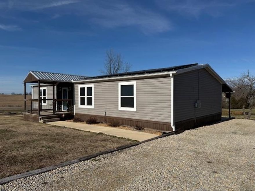 HOME, SHOP, POND, ACREAGE!!  2021 custom built Hamilton Manufactured Home is 2010 SF. 3 bedrooms and 2 bathrooms including a master suite with garden tub and separate walk in shower. Double vanity and built in shelving. Large bedroom and walk in closet. Kitchen, dining and living room combo with stainless appliances, bar and country sink. Gorgeous electric fireplace and built-ins in the living room. Huge laundry room with cabinetry and utility sink. Nice 300 SF sunroom and a 300 SF covered patio overlooking the pond! Other amenities include metal roof, walk in closets in every room, 4 solar Ring security cameras, custom cut window blinds, all interior LED lighting and solar panels designed to reduce electricity usage by 85% which is reflected with his $43 summer electric bills!  There is a 40 ft container shop with roof and lean to. Also water line and electric. Well water and septic system. Home has concrete footers, with concrete block piers and hurricane resistant straps according to AR law per owner. The 3.5 acres are nice, level and open with a small pond. Located on corner of 2 paved road just 1 mile to Supply Country Store, 4 miles to Maynard & 18 to Pocahontas.