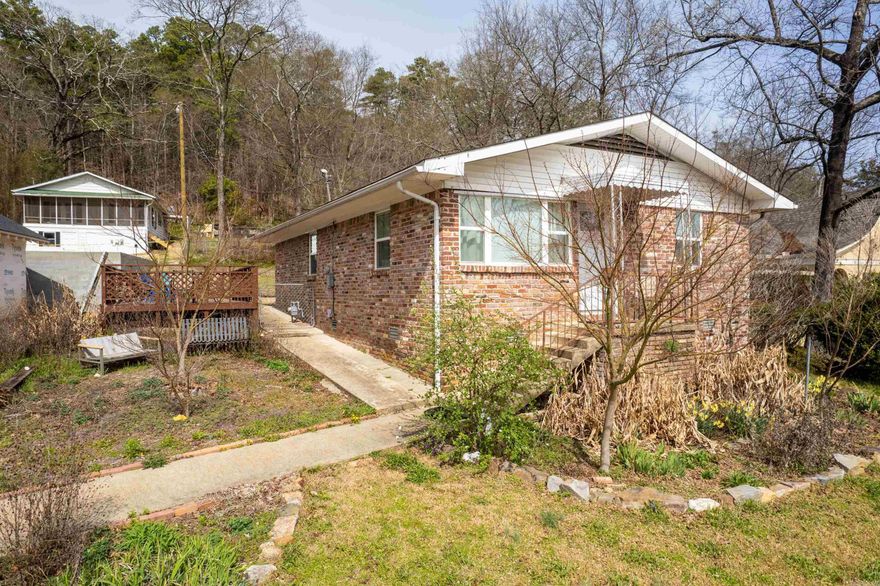 Updated and remodeled licensed S-T-R in the Historic District next to West Mountain Dr and the National Park's West Mountain Trail system selling furnished and turnkey! Amazing Quapaw/Prospect location on this little gem that puts you close to Historic Downtown, Sidetown, and Uptown in a walking neighborhood where front porch get-togethers are still a thing! The open concept living areas make the space live large, perfect for entertaining. Original hardwoods add warmth and charm while modern appliances and updates add to the light and bright feel. Don't let the front steps fool you, rear entry off Curve Terrace with a carport offers convenient entry to the house. Not easy to find anything in this location for this price point especially with S-T-R licensing, so whether your downsizing to a dream location or investing in downtown Hot Springs, schedule your showing today!