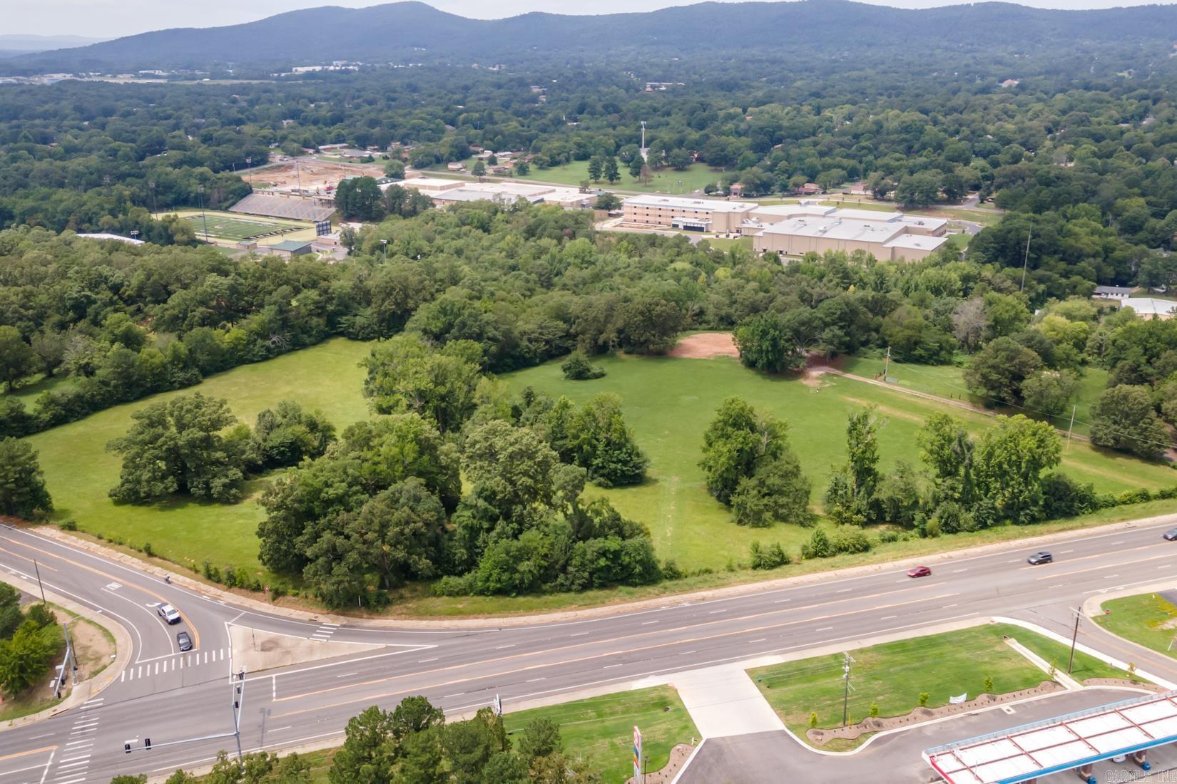 Incredible tract of land with almost 18 acres at a prime commercial location at the corner of Higdon Ferry and Lakeshore Drive. Easy access from several sides positioned perfectly between the hospital, shopping, Oaklawn Park/Casino with multiple use options and opportunities. While this property is currently zoned residential & agriculture, the city has attempted to rezone for commercial for many years (seller is prepared to work through rezoning process with buyer).Utilities available are city water, natural gas and electricity. Contact listing agent for more information including topography/boundary survey, appraisal and disclosures.