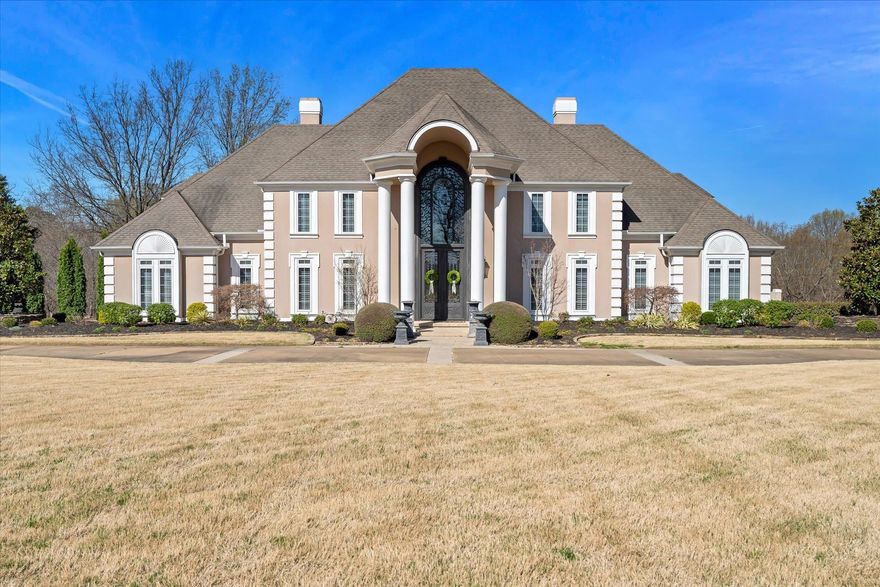 Elegant. Magnificent. Grand. This estate home on 4 acres is in the exclusive RidgePointe Country Club subdivision. The 2-story soaring entrance to the foyer & living room is breathtaking. Hardwood flooring with mahogany enlay leads you seamlessly throughout the main level of this lavish home. The chef's kitchen is beautifully & thoughtfully appointed with large island & stunning onyx & mother of pearl backsplash. Open to the kitchen is a 2nd living area for guests to mingle and continue to share in the kitchen activities. The primary bed & bath is a retreat with a luxurious spa bathroom. A 2nd large dining area or sunroom, leads onto the screened in porch with wooden ceilings, gas grill, sink, refrigerator, & gas firepit. The built-in hot tub with stone accents in this incredibly private setting is so peaceful. You're overlooking 17 acres between you and your nearest backdoor neighbor. Upstairs has picturesque views and 2 more living areas, 3 bedrooms, and 2 full bathrooms. Downstairs is a walk-out suite with kitchenette, full bathroom, with separate private driveway located off the adjoining Sawgrass Street & garage. Truly, a one of a kind that you will love to call your home!