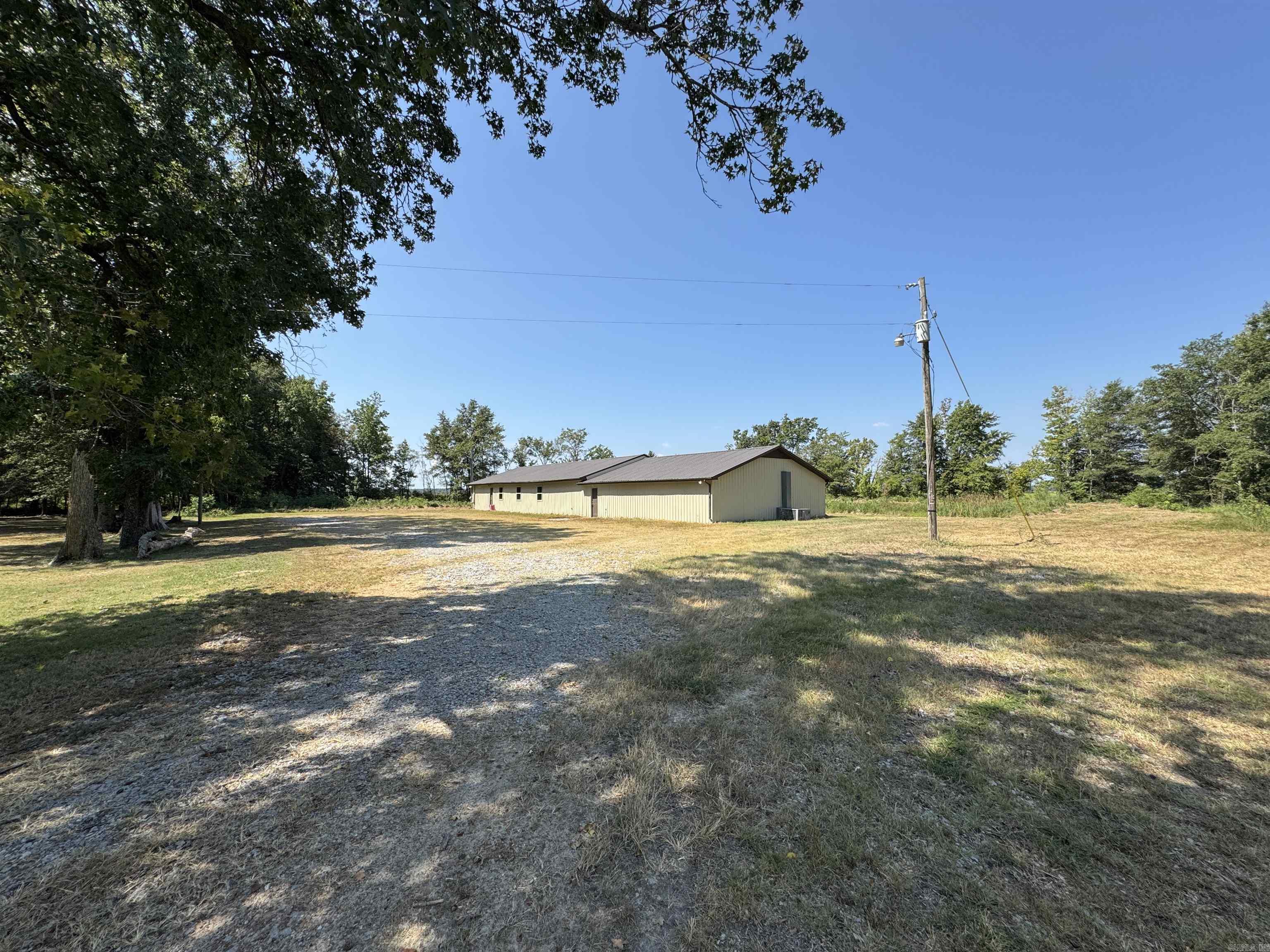 If you are a duck hunter and own or lease property near the Fair Oaks area and want to add a lodge to your portfolio, give this one a look.Ā Listed at just over $68/ft2 you will struggle find an existing camp this nice or build one in this price range. Inside, it has been fully renovated with little to no use since the project was completed. The large, commercial Motak gas range and ovens convey and will easily prepare the largest meal you could imagine. It has 6 bedrooms (9 bunks for a total of 18 beds included) and 4 full baths so that you can give each member their own room and bathroom if you have a small group or easily sleep well over 20 people if you have a big crew. The exterior measures 110'x34' and is all metal, including the roof, making it a very low maintenance property to help keep your annual expenses and effort low. There is small pond behind the structure that provides an opportunity to create an outdoor entertainment space (fire pit, outdoor kitchen, etc) plus a place to train your dog in the afternoons. Plenty of room for a shop if you need a place for your equipment and decoys. All pictured furnishings convey.