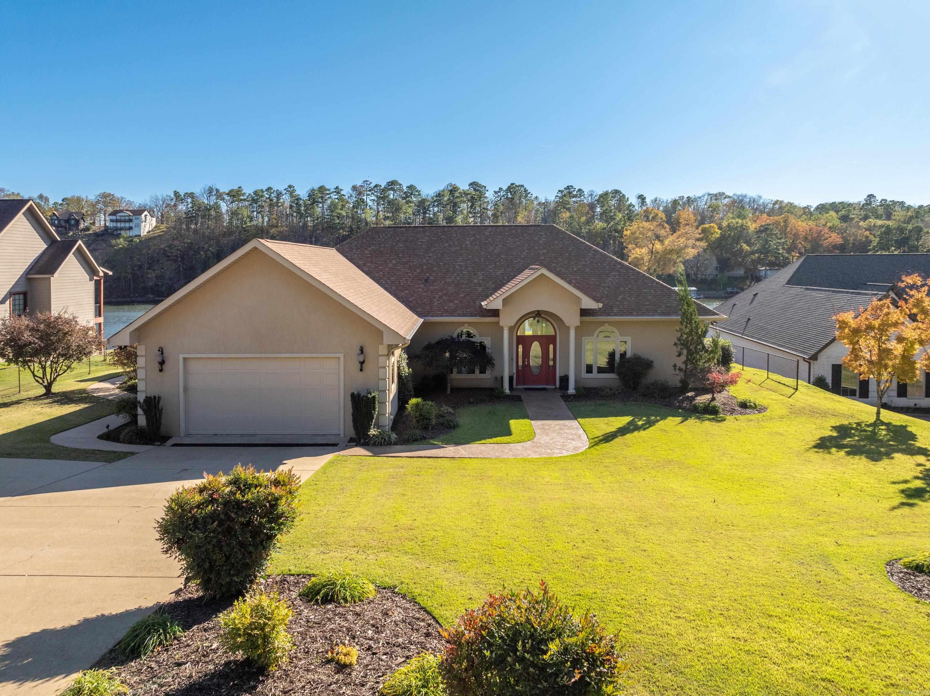 Welcome to your new home on Lake Hamilton!! This beautiful 1-story ranch boasts 2,764 sq ft of thoughtfully designed living space, featuring 3 spacious bedrooms and 3.5 baths, as well as an office. Vaulted ceilings and an open floor plan create plenty of space to host, entertain, and relax in this waterfront home. The outdoor space is a true oasis! The beautifully landscaped backyard has an outdoor entertaining area that offers gorgeous views of the lake—perfect for relaxing evenings or hosting gatherings. The outdoor cabana features a large storage room, full bathroom, and outdoor kitchen, equipped with a built-in grill, refrigerator, and a lot of storage. It has all your lake needs met with a stationary two-stall boat dock with lifts and year-round water. Other noteworthy amenities are central vacuum, tankless water heater, sprinkler system and a new roof. Location is everything! You’ll be just minutes away from shopping, dining, and Oaklawn Park. Set on a generous .89-acre lot, this home provides ample space for you to enjoy all that lakefront living has to offer. Do not miss your chance to experience this incredible lifestyle—schedule your showing today!