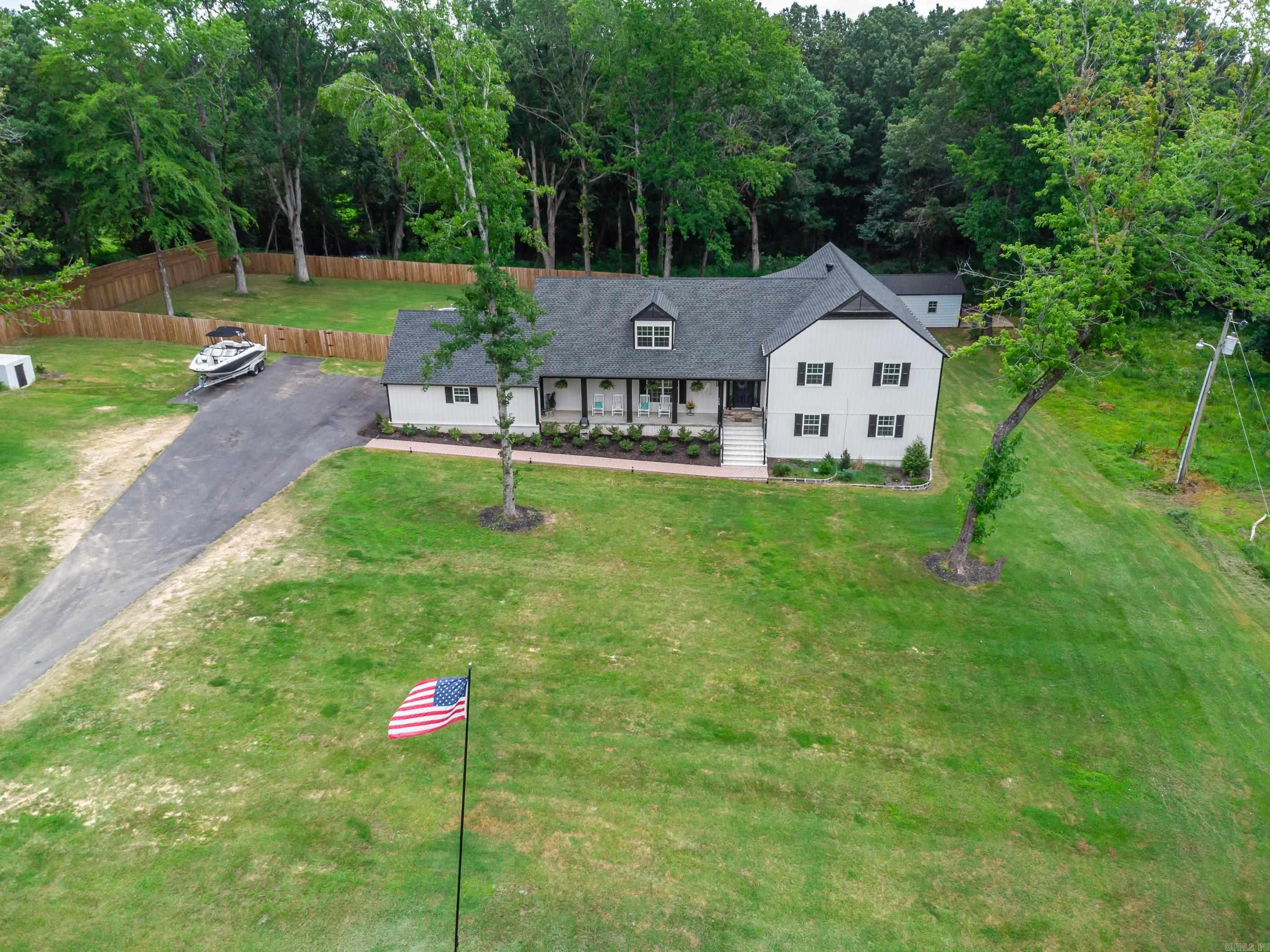 Stunning modern farmhouse that sits on 6 acres of picturesque land, offering 6 spacious bedrooms, 4.5 modern bathrooms, and a gourmet kitchen with a butler’s pantry. Enjoy a theatre room, shop, and a covered deck complete with a TV—perfect for relaxation and entertaining. Whether you're looking for a peaceful retreat or a home with two master suites, this property has it all. From ATV trails to views of a meadow frequented by deer and wildlife, this remodeled home is an ideal sanctuary for any family. Located just five minutes from Walmart, medical facilities, restaurants, and all the amenities that Searcy and Harding University offer, it’s the perfect balance of country living with modern convenience. With the potential to serve as an Airbnb or retreat venue, this property offers flexibility for various uses. Plus, you can keep horses and chickens! Enjoy the beauty of nature, complete with a firepit, creek and woods, while benefiting from high-speed internet & ample space for children to roam. Fenced for privacy, it also features a storm shelter and mineral rights that convey. With beautiful sunrises and sunsets, this rare piece of paradise is truly a one-of-a-kind opportunity!